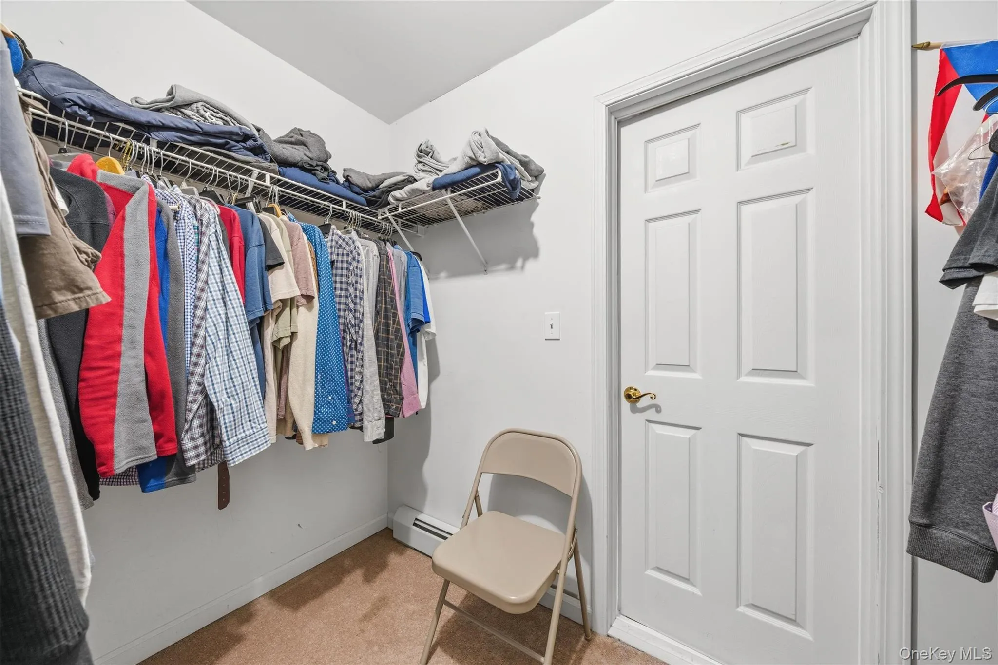 Primary Bedroom Walk-in closet & Door to Attic Storage Space Primary Bedroom Walk-in closet & Door to Attic Storage Space