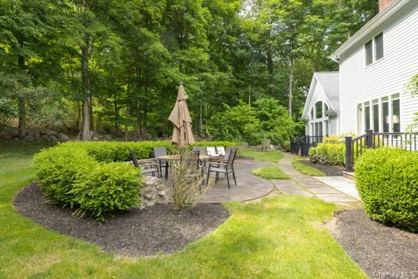 Stone patio surrounding manicured shrubs Stone patio surrounding manicured shrubs
