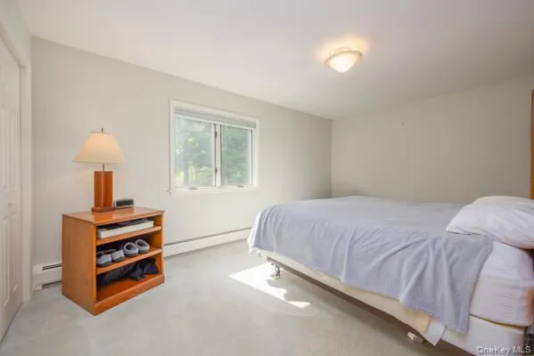 Spacious room featuring light-colored carpeting, a double window, and a flush mount ceiling light fixture Spacious room featuring light-colored carpeting, a double window, and a flush mount ceiling light fixture