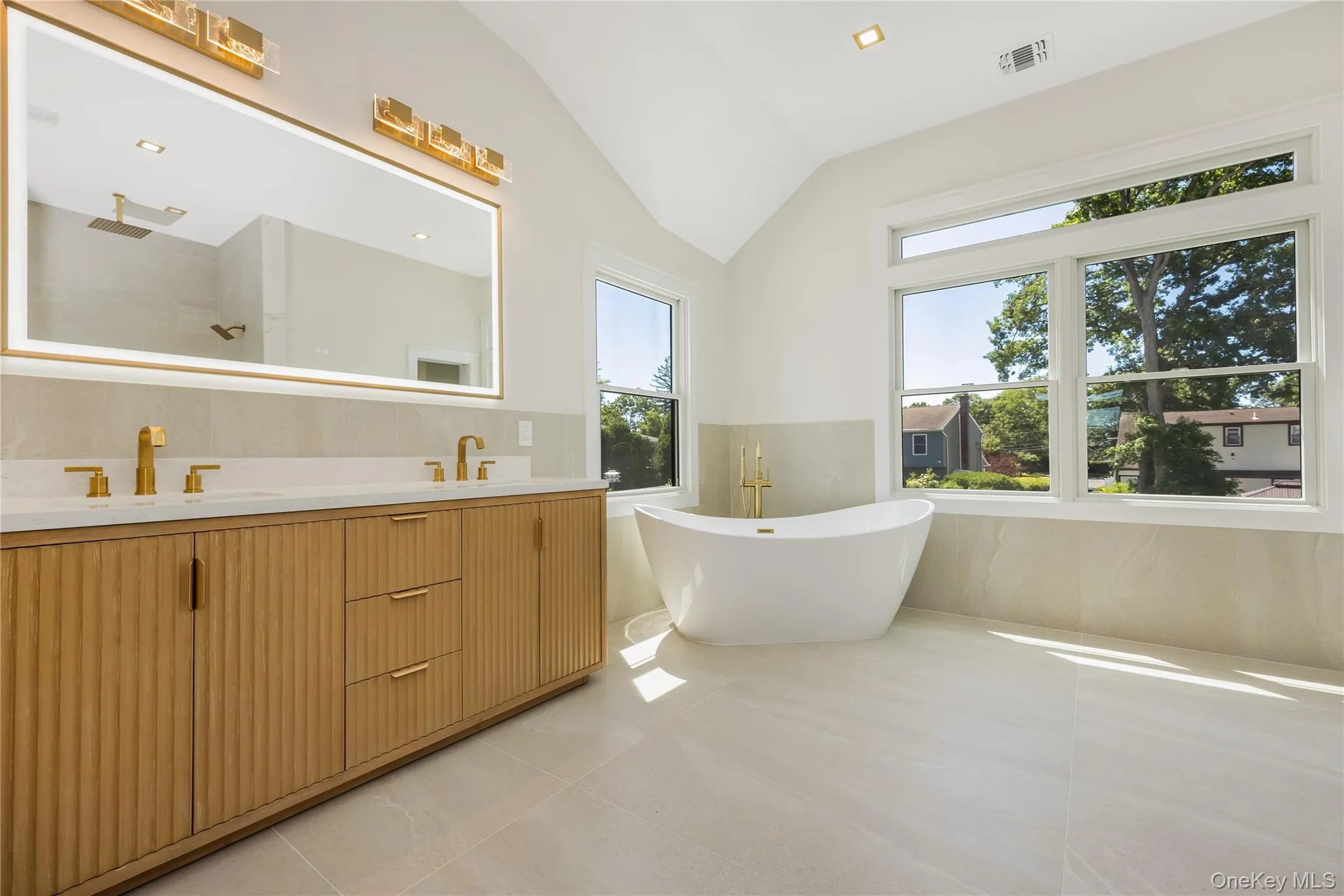 Spacious primary spa like bath with free standing soaking tub Spacious primary spa like bath with free standing soaking tub