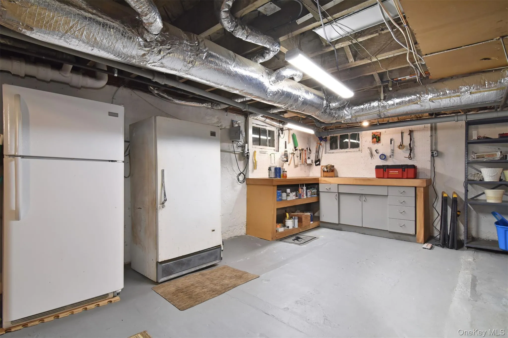 Large basement with work area and laundry space Large basement with work area and laundry space