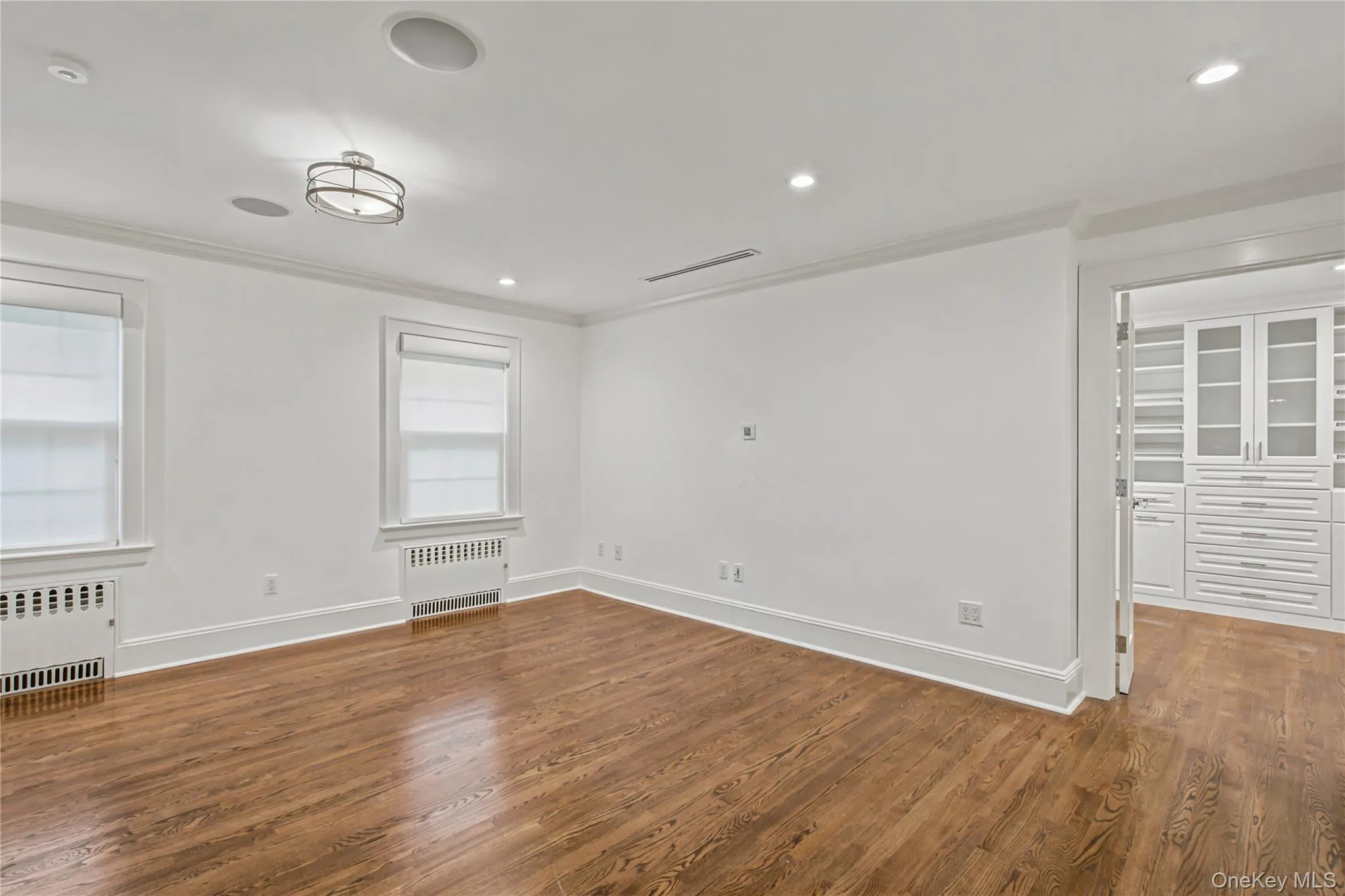 Large primary en suite bathroom with huge customized walk in closet Large primary en suite bathroom with huge customized walk in closet