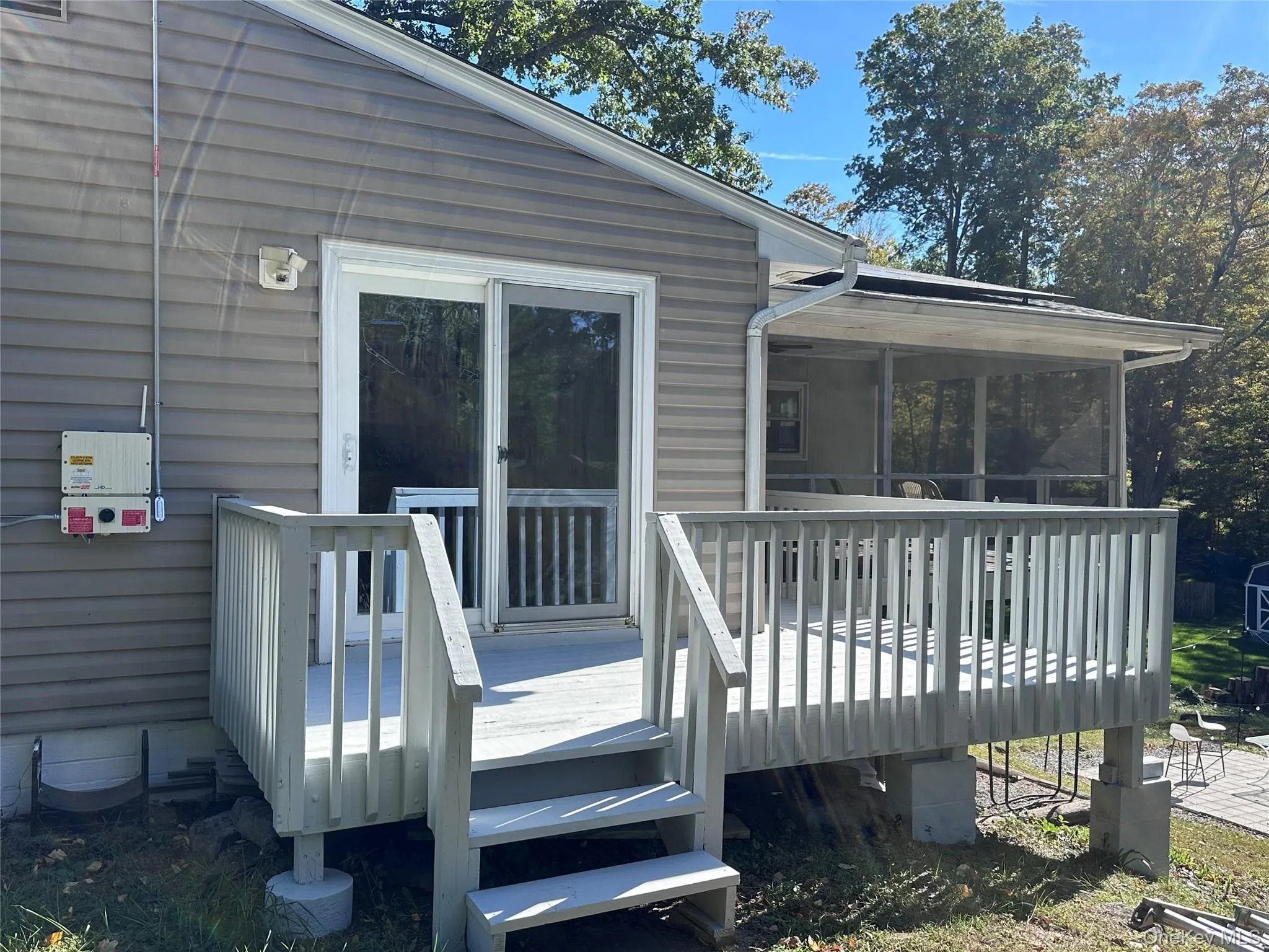 Sliders walk out to deck that wraps into the sunroom Sliders walk out to deck that wraps into the sunroom