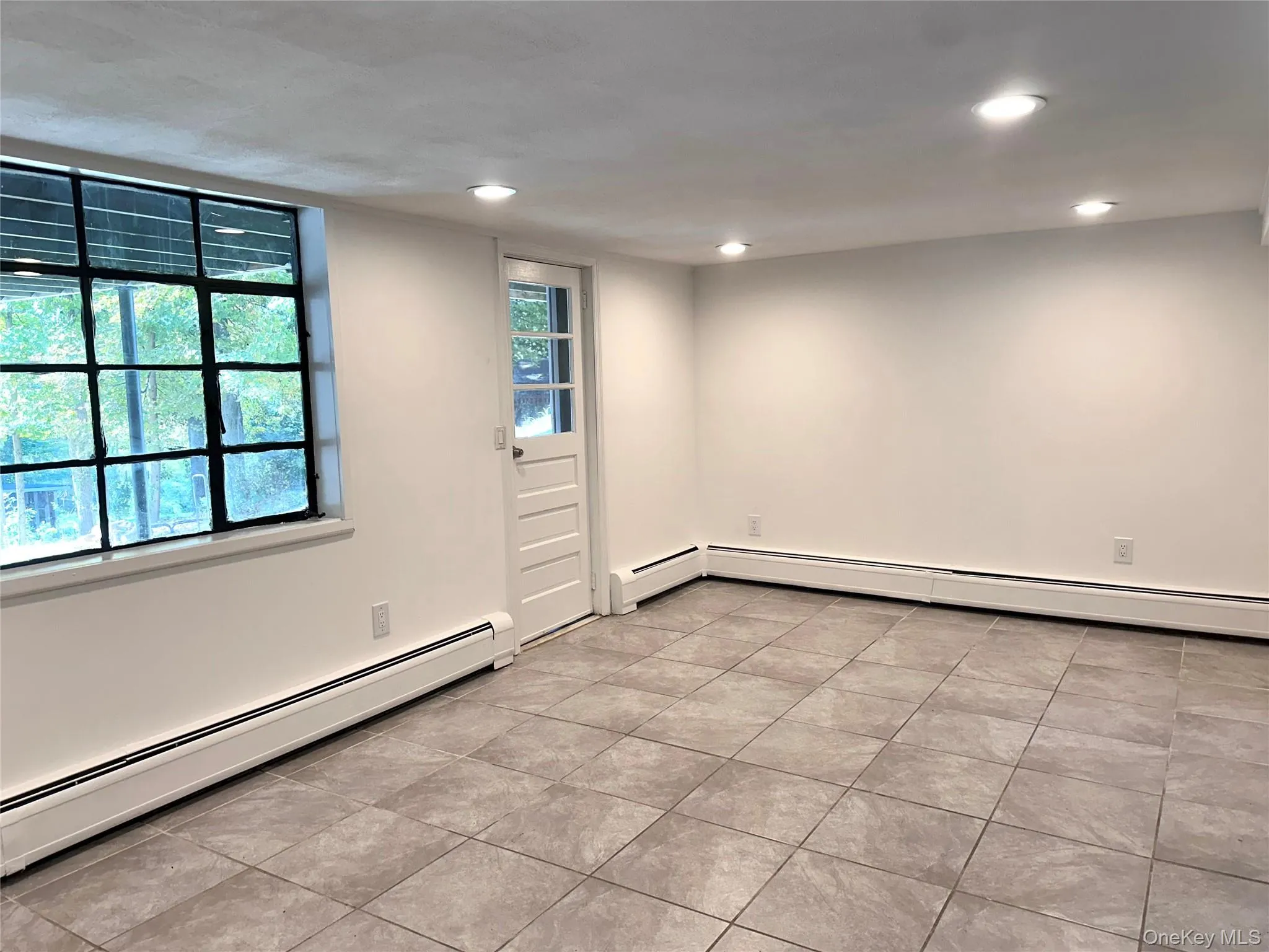 Tiled floor in one of two large lower-level rooms Tiled floor in one of two large lower-level rooms