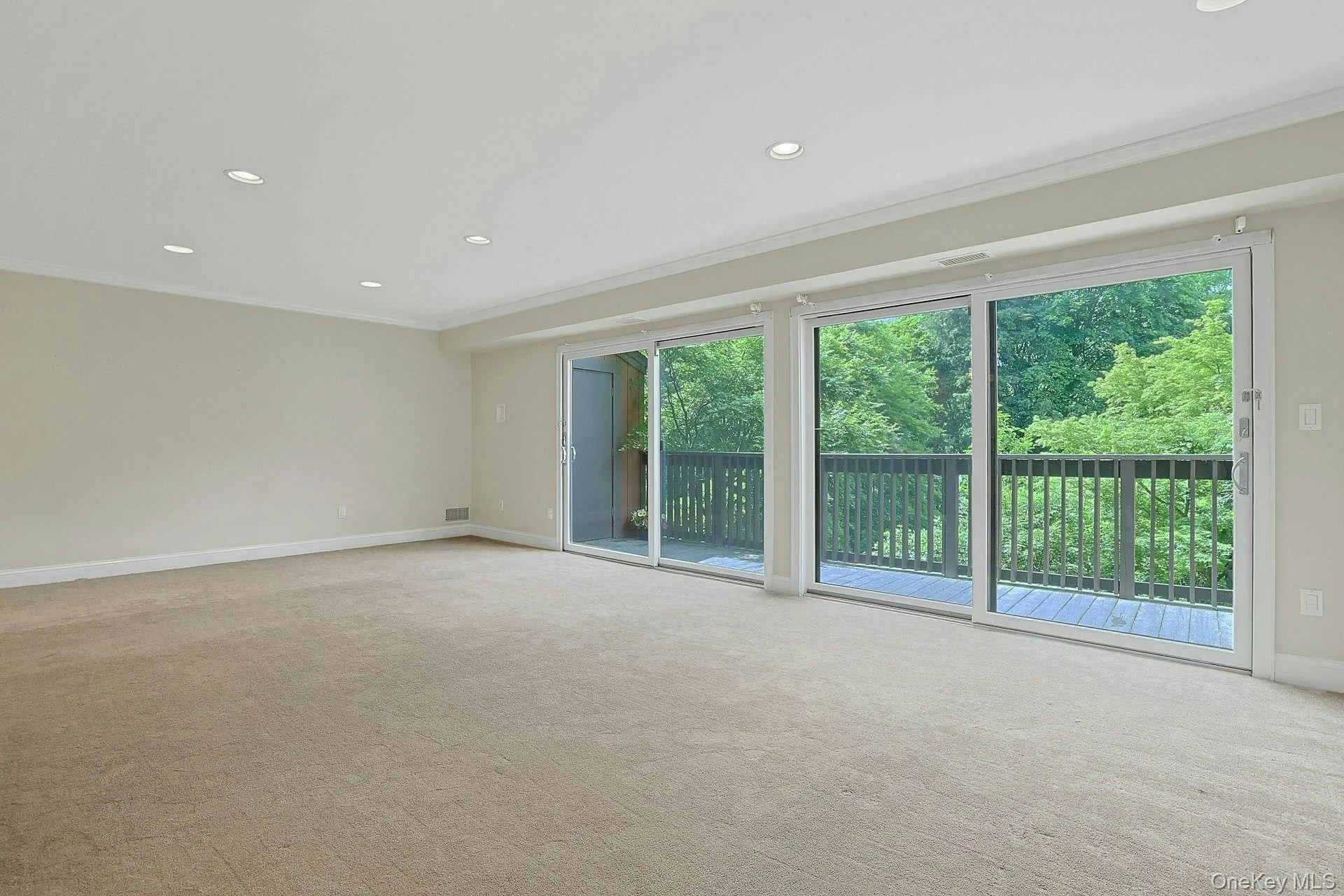 Living space with double sliding glass doors to deck Living space with double sliding glass doors to deck