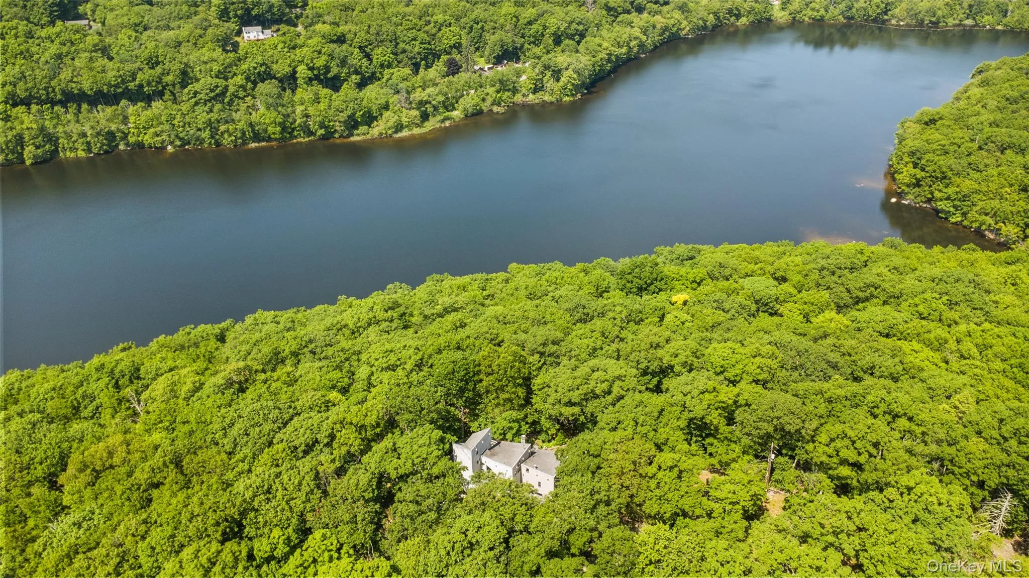 Aerial perspective of a truly unique estate, set on 6 private acres and surrounded by 30 + acres of protected natural beauty. From above, the home’s impressive scale, distinctive design, and extraordinary setting come into full view, with reservoirs nearby and a remarkable sense of peace, privacy, and seclusion in every direction. Aerial perspective of a truly unique estate, set on 6 private acres and surrounded by 30 + acres of protected natural beauty. From above, the home’s impressive scale, distinctive design, and extraordinary setting come into full view, with reservoirs nearby and a remarkable sense of peace, privacy, and seclusion in every direction.