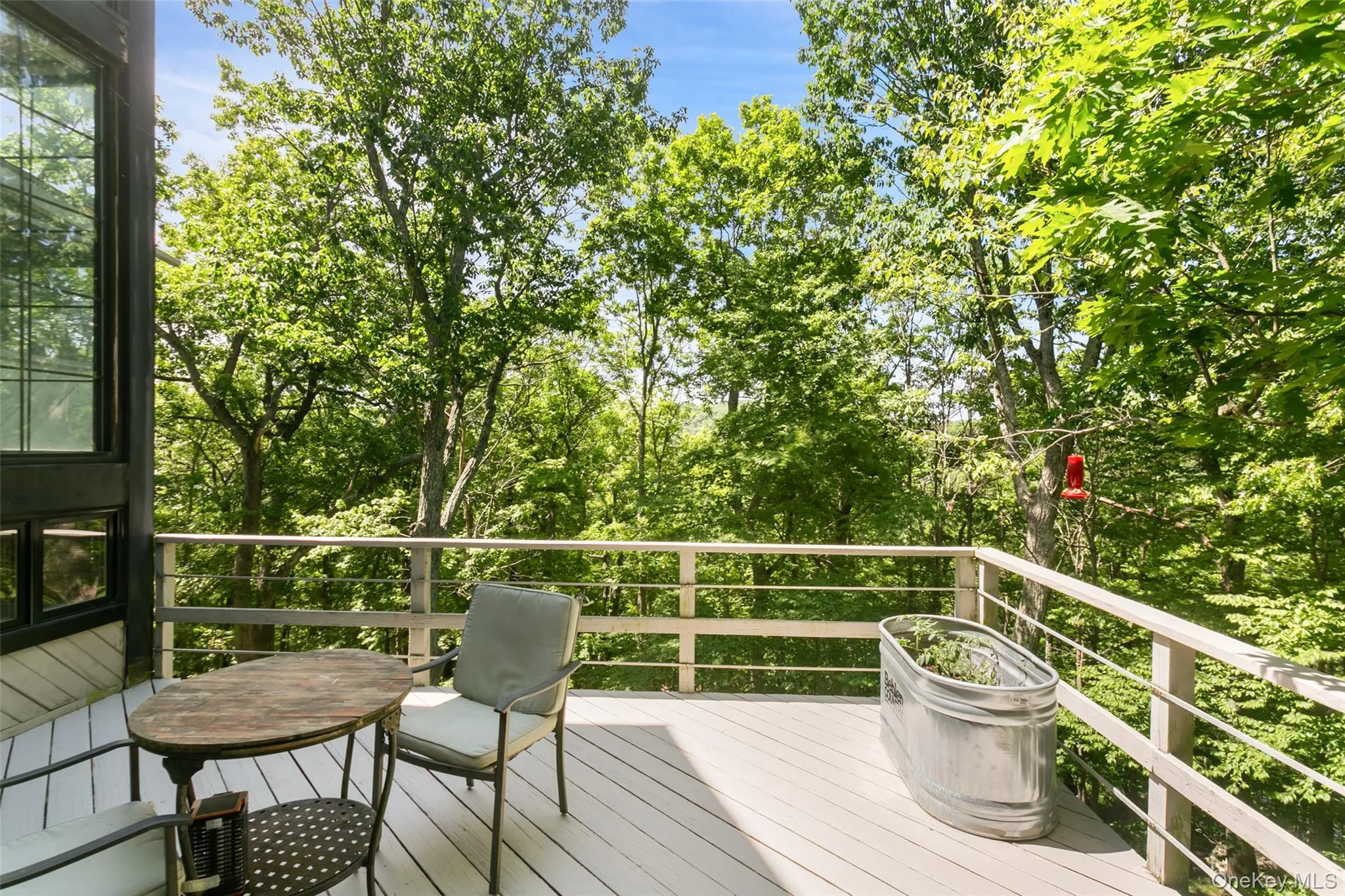 A spacious deck overlooks acres of peaceful reservoir land, offering a rare sense of privacy and natural beauty. Enjoy quiet mornings, outdoor dining, and relaxing evenings surrounded by wooded views, with seasonal glimpses of the reservoir adding a special backdrop throughout the year. This serene setting feels tucked away, yet still close to everything. A spacious deck overlooks acres of peaceful reservoir land, offering a rare sense of privacy and natural beauty. Enjoy quiet mornings, outdoor dining, and relaxing evenings surrounded by wooded views, with seasonal glimpses of the reservoir adding a special backdrop throughout the year. This serene setting feels tucked away, yet still close to everything.