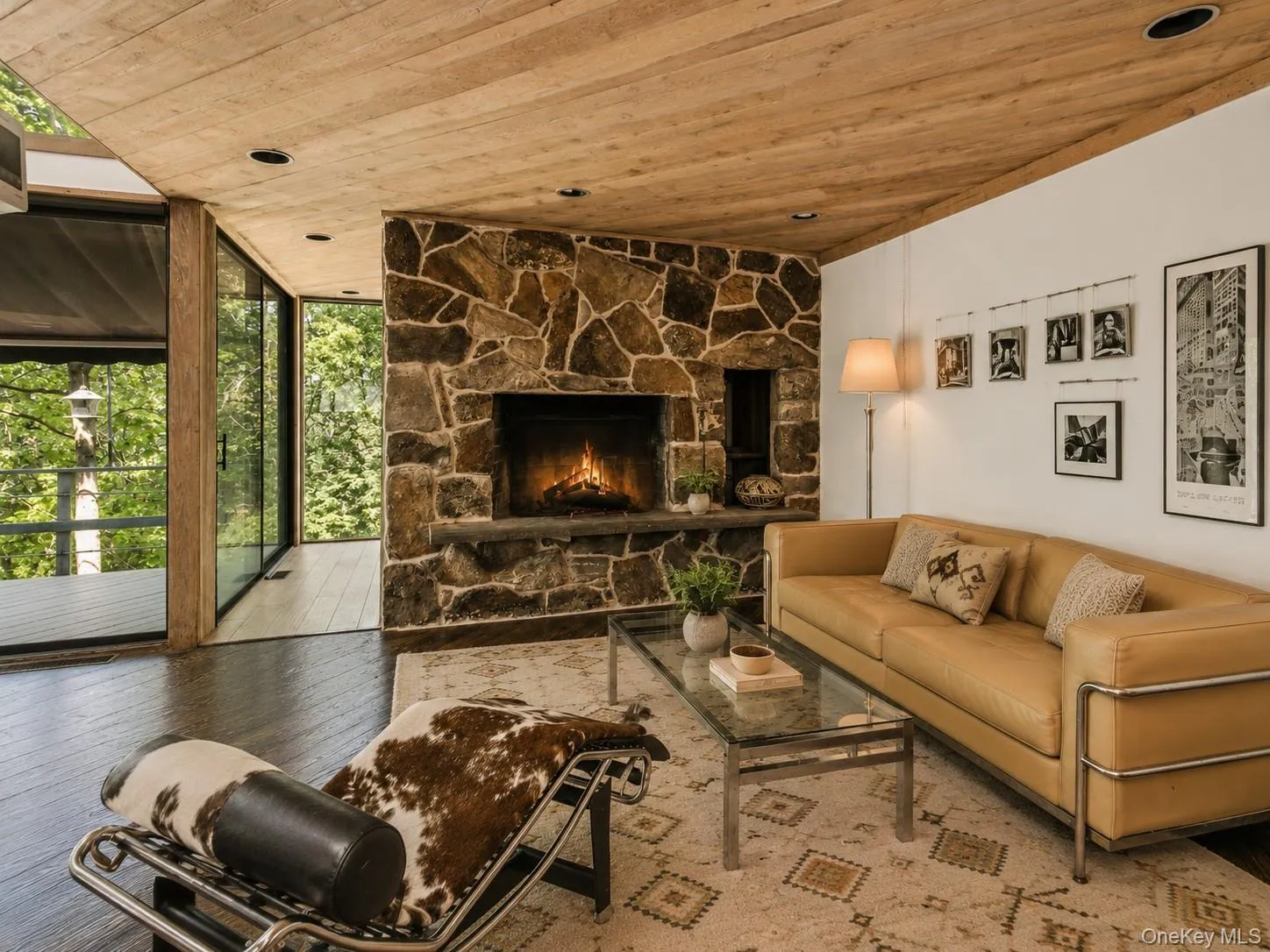 Spacious Living room with cathedral ceilings, floor to ceiling windows, sliding glass doors and a beautiful stone fireplace Spacious Living room with cathedral ceilings, floor to ceiling windows, sliding glass doors and a beautiful stone fireplace