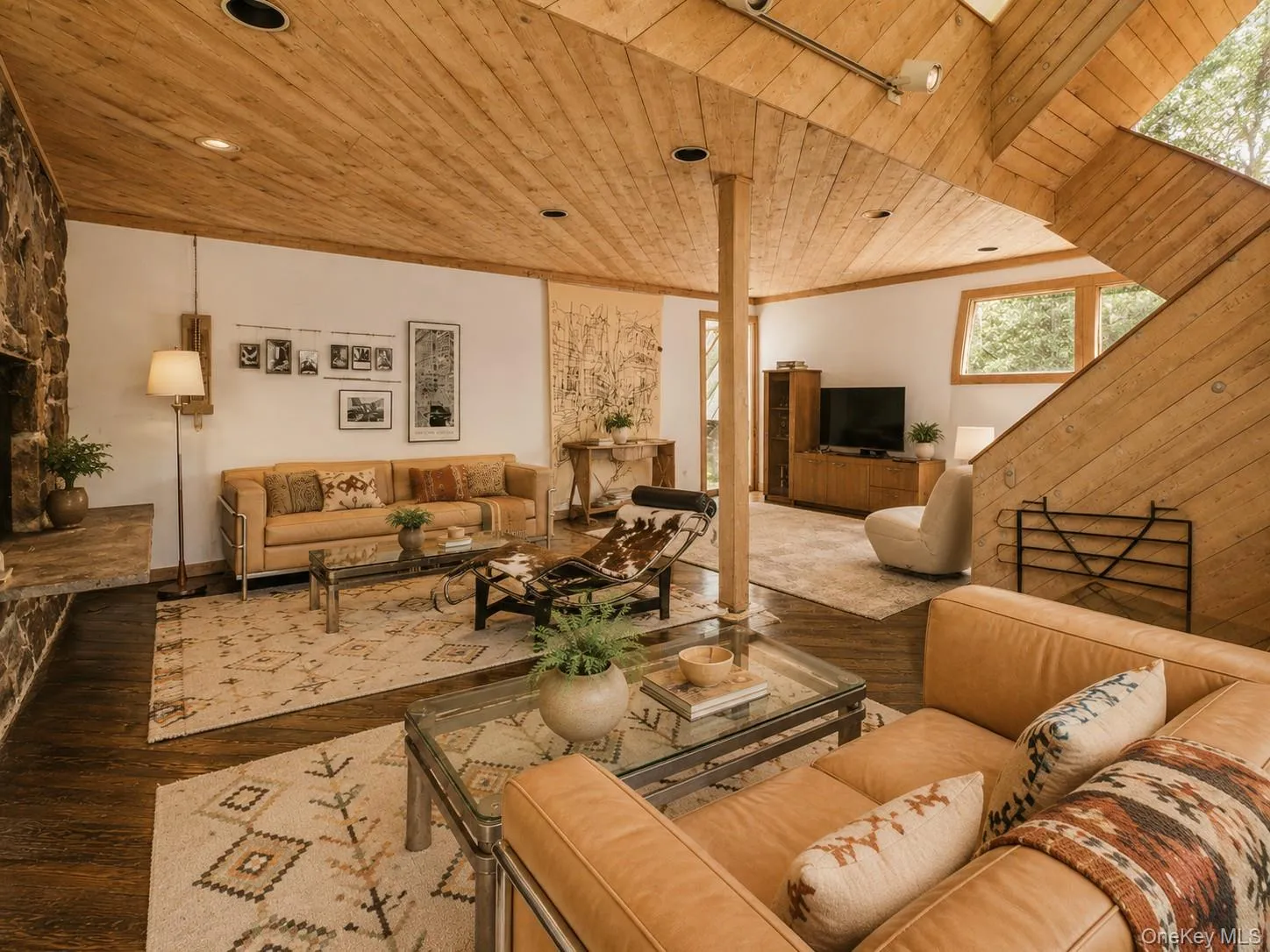 Spacious Living room with cathedral ceilings, floor to ceiling windows, sliding glass doors and a beautiful stone fireplace Spacious Living room with cathedral ceilings, floor to ceiling windows, sliding glass doors and a beautiful stone fireplace