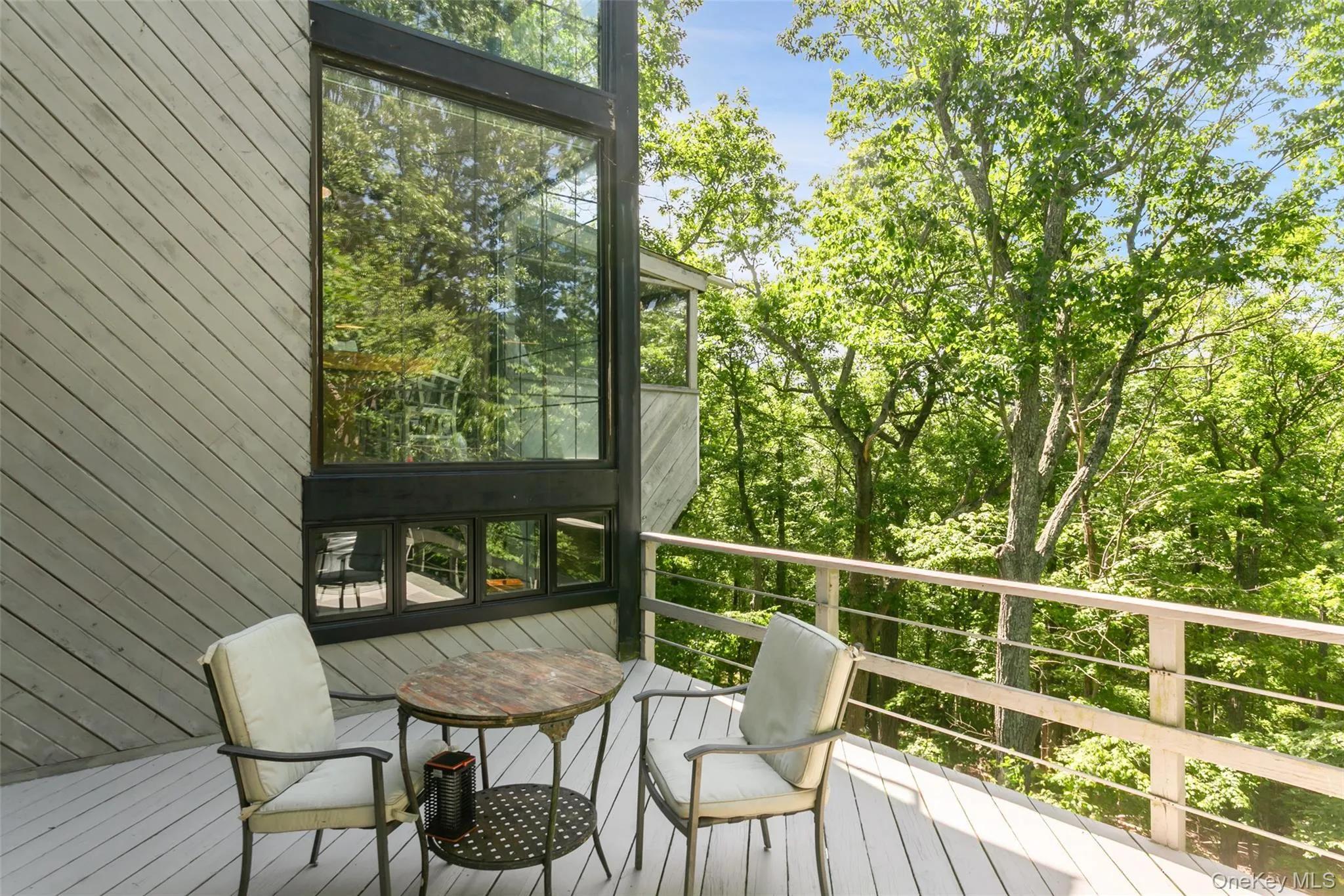 A spacious deck overlooks acres of peaceful reservoir land, offering a rare sense of privacy and natural beauty. Enjoy quiet mornings, outdoor dining, and relaxing evenings surrounded by wooded views, with seasonal glimpses of the reservoir adding a special backdrop throughout the year. This serene setting feels tucked away, yet still close to everything. A spacious deck overlooks acres of peaceful reservoir land, offering a rare sense of privacy and natural beauty. Enjoy quiet mornings, outdoor dining, and relaxing evenings surrounded by wooded views, with seasonal glimpses of the reservoir adding a special backdrop throughout the year. This serene setting feels tucked away, yet still close to everything.