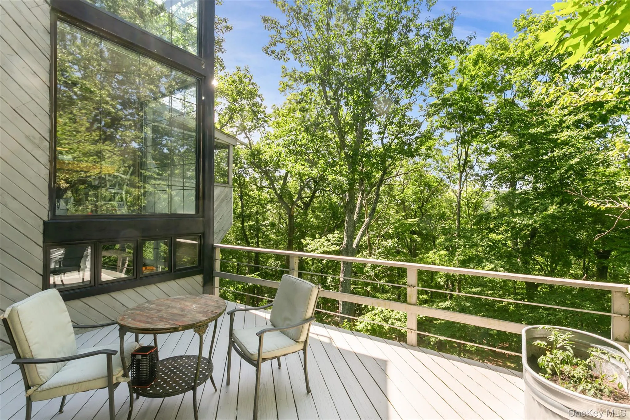 A spacious deck overlooks acres of peaceful reservoir land, offering a rare sense of privacy and natural beauty. Enjoy quiet mornings, outdoor dining, and relaxing evenings surrounded by wooded views, with seasonal glimpses of the reservoir adding a special backdrop throughout the year. This serene setting feels tucked away, yet still close to everything. A spacious deck overlooks acres of peaceful reservoir land, offering a rare sense of privacy and natural beauty. Enjoy quiet mornings, outdoor dining, and relaxing evenings surrounded by wooded views, with seasonal glimpses of the reservoir adding a special backdrop throughout the year. This serene setting feels tucked away, yet still close to everything.