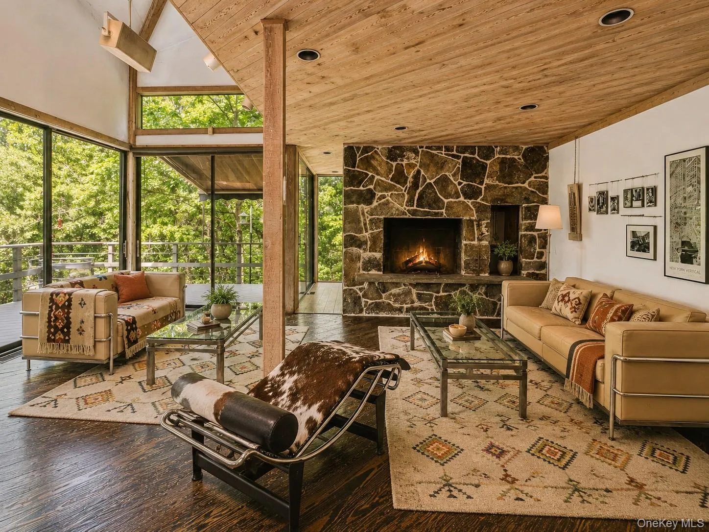 Spacious Living room with cathedral ceilings, floor to ceiling windows, sliding glass doors and a beautiful stone fireplace Spacious Living room with cathedral ceilings, floor to ceiling windows, sliding glass doors and a beautiful stone fireplace