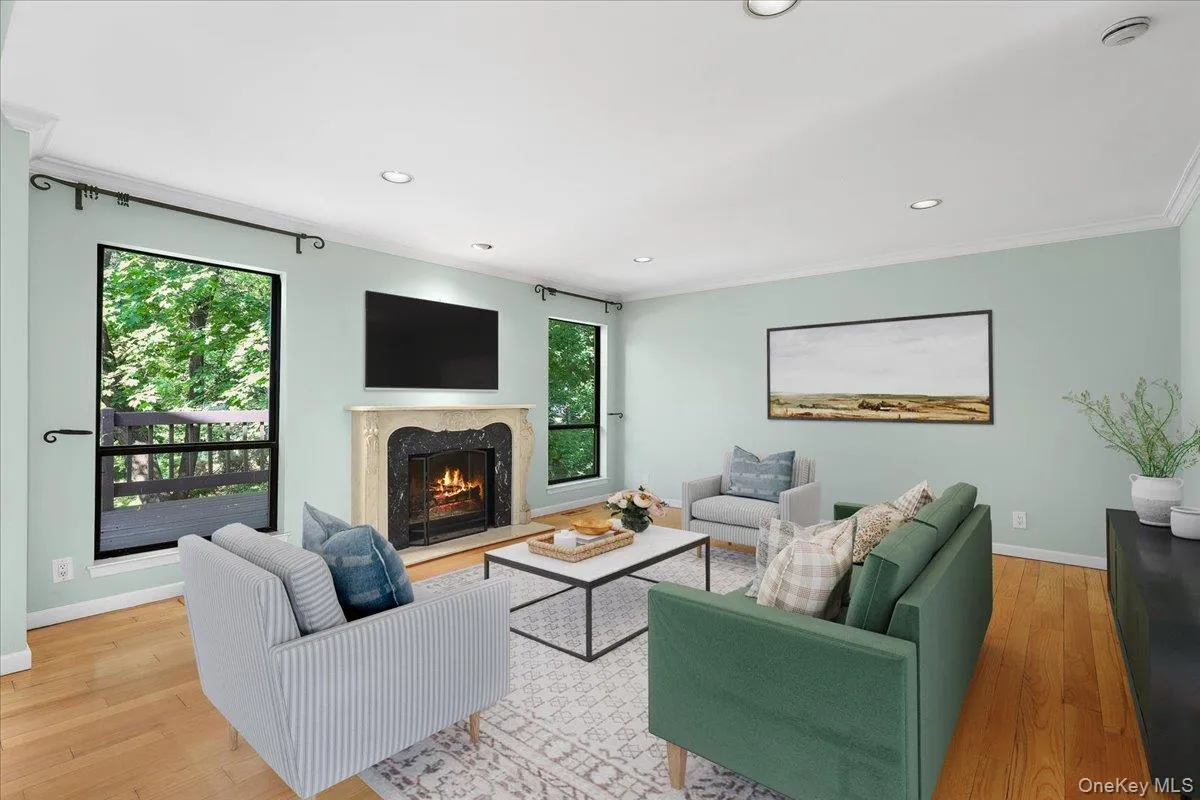 Inviting living room anchored by a gas fireplace and framed by treetop views. Inviting living room anchored by a gas fireplace and framed by treetop views.