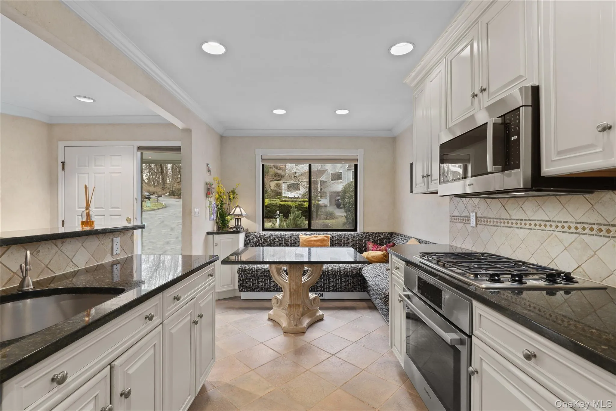 Eat-in kitchen with breakfast bar, built-in storage, and a casual dining nook. Eat-in kitchen with breakfast bar, built-in storage, and a casual dining nook.