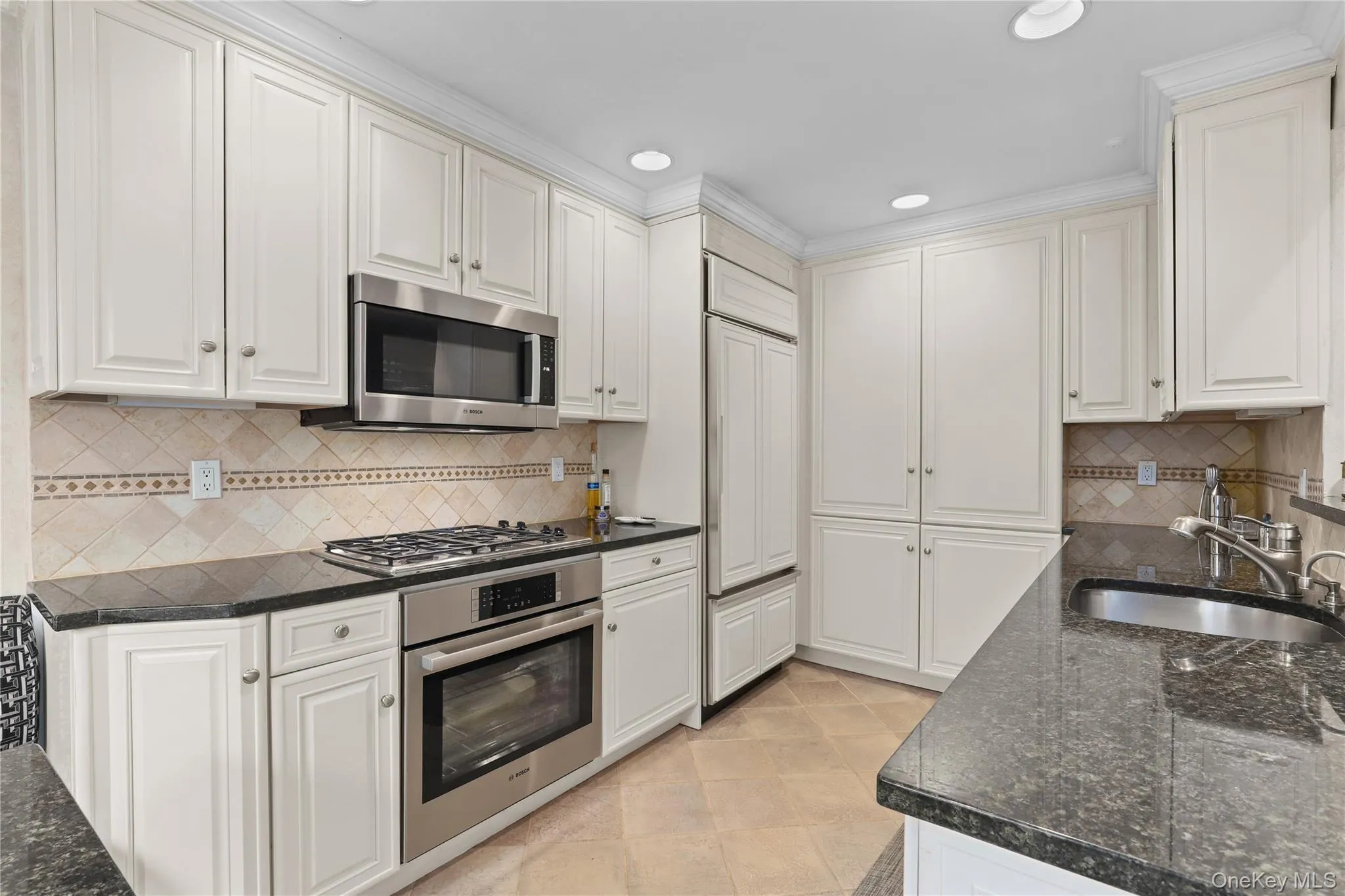 Classic kitchen with granite counters, stainless steel appliances, and abundant cabinetry. Classic kitchen with granite counters, stainless steel appliances, and abundant cabinetry.