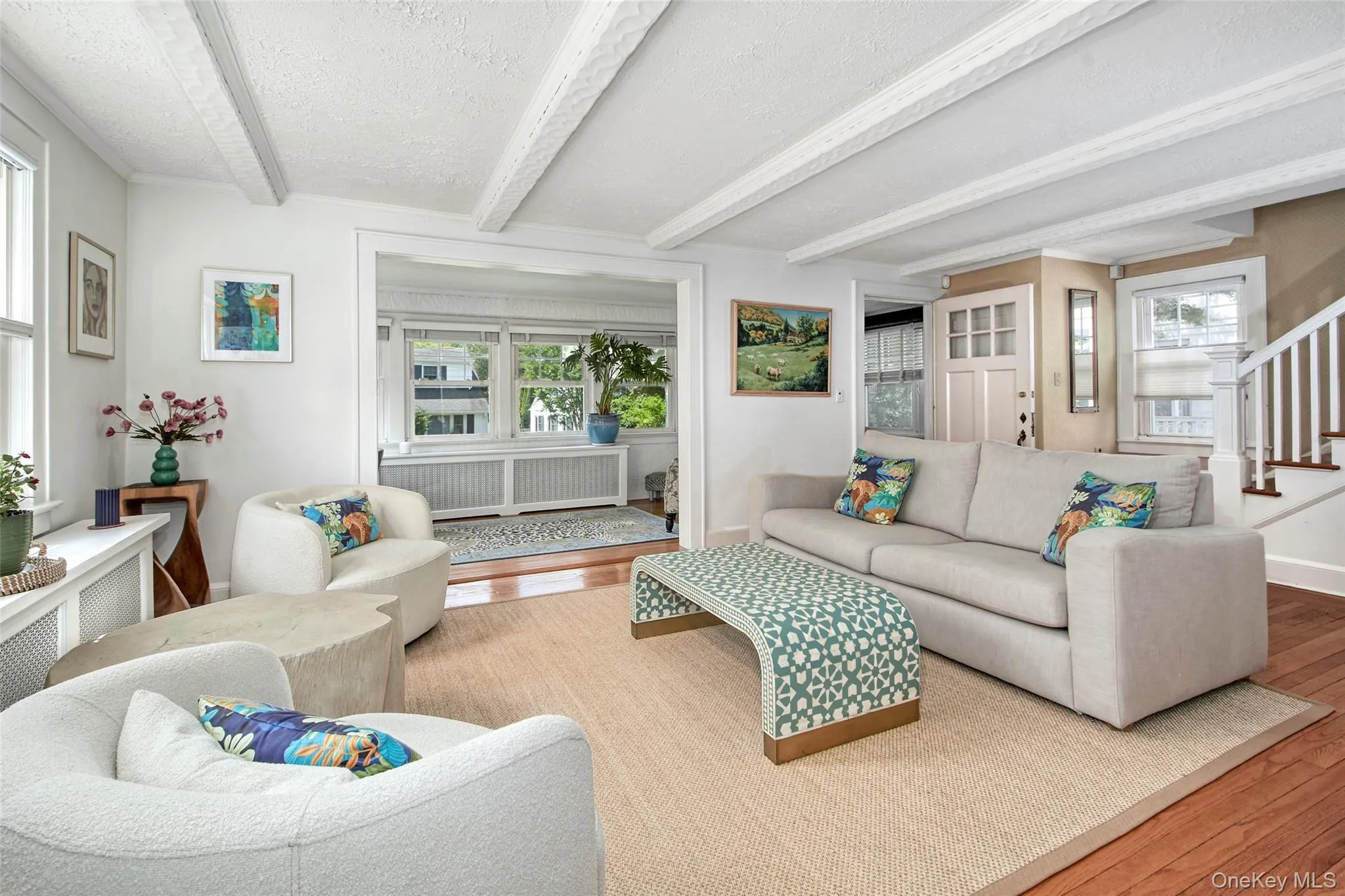 Beautifully furnished living room with comfortable seating, designer lighting, curated artwork, and thoughtfully selected furnishings creating a warm and inviting gathering space for relaxing or entertaining. Beautifully furnished living room with comfortable seating, designer lighting, curated artwork, and thoughtfully selected furnishings creating a warm and inviting gathering space for relaxing or entertaining.