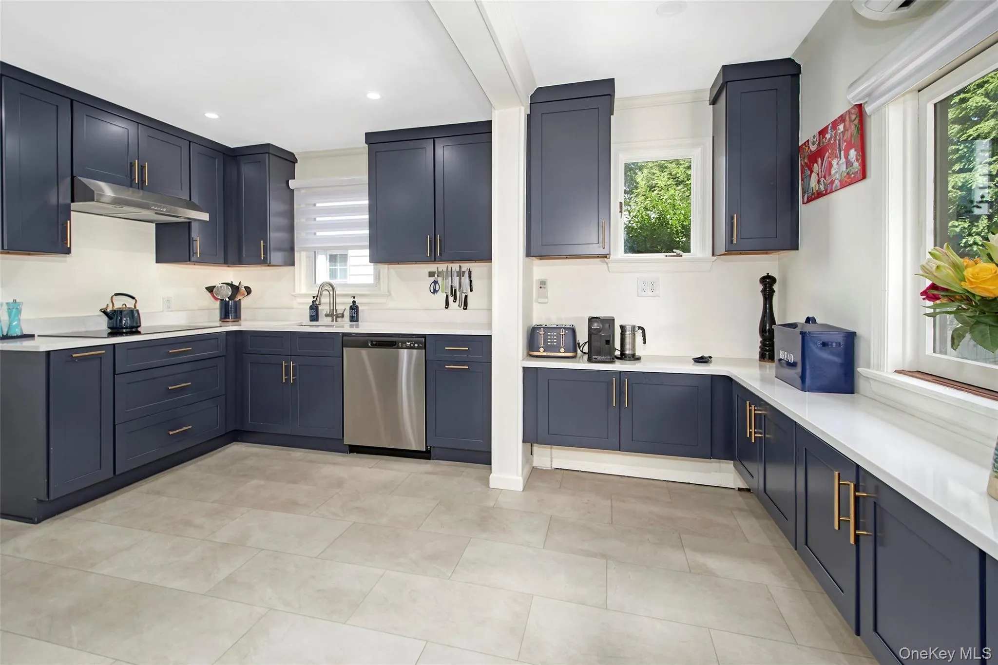 A beautifully renovated kitchen designed for both functionality and style, featuring custom cabinetry, expansive quartz countertops, stainless steel appliances, induction cooking, double ovens, abundant storage, and a dedicated workstation. Fully outfitted with cookware,, serving pieces, and kitchen essentials, offering a seamless move-in-ready experience for cooking, entertaining, and everyday enjoyment. A beautifully renovated kitchen designed for both functionality and style, featuring custom cabinetry, expansive quartz countertops, stainless steel appliances, induction cooking, double ovens, abundant storage, and a dedicated workstation. Fully outfitted with cookware,, serving pieces, and kitchen essentials, offering a seamless move-in-ready experience for cooking, entertaining, and everyday enjoyment.