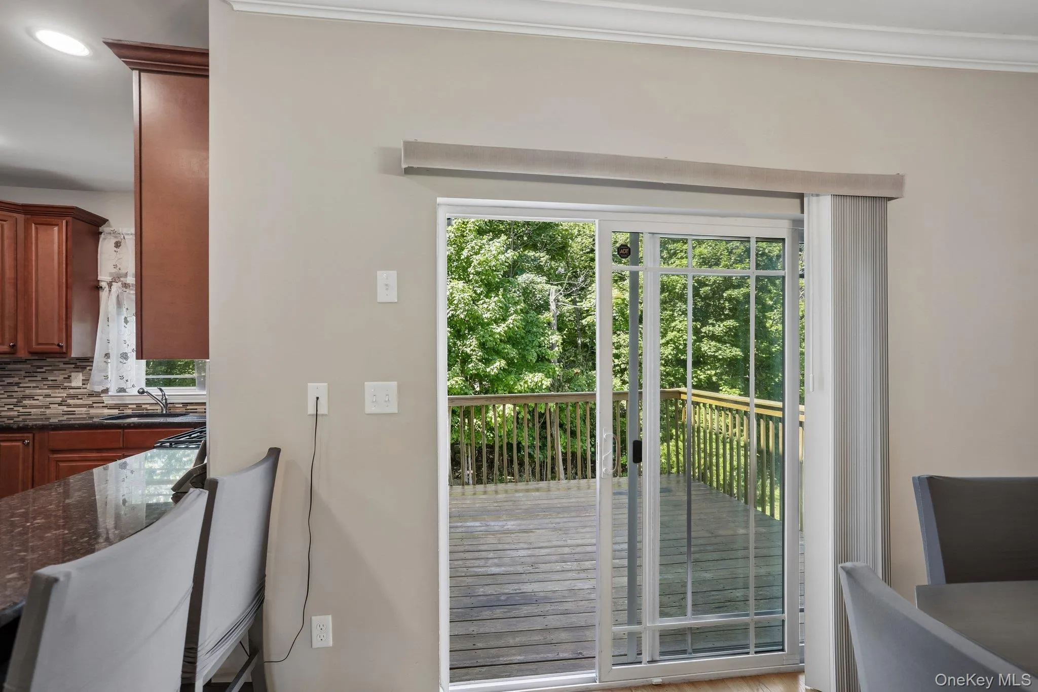 Sliders from dining area to deck which has steps to the yard. Sliders from dining area to deck which has steps to the yard.