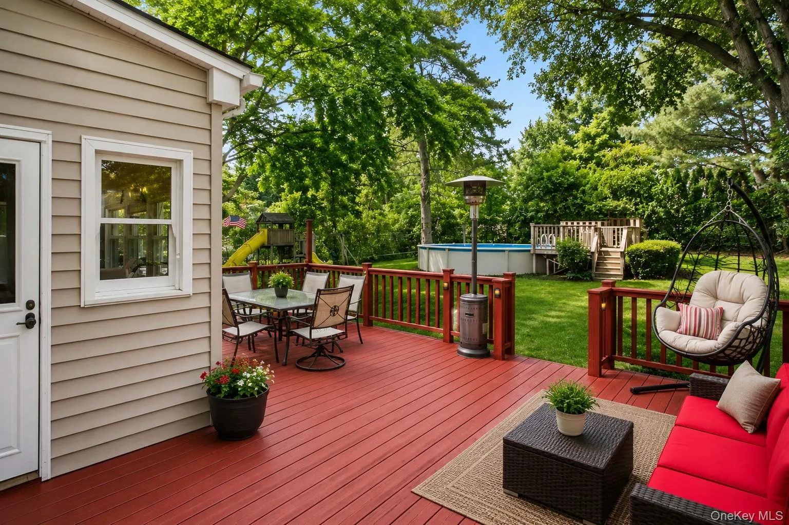 Outside, enjoy a large deck just off the back porch overlooking the beautiful, level backyard Outside, enjoy a large deck just off the back porch overlooking the beautiful, level backyard