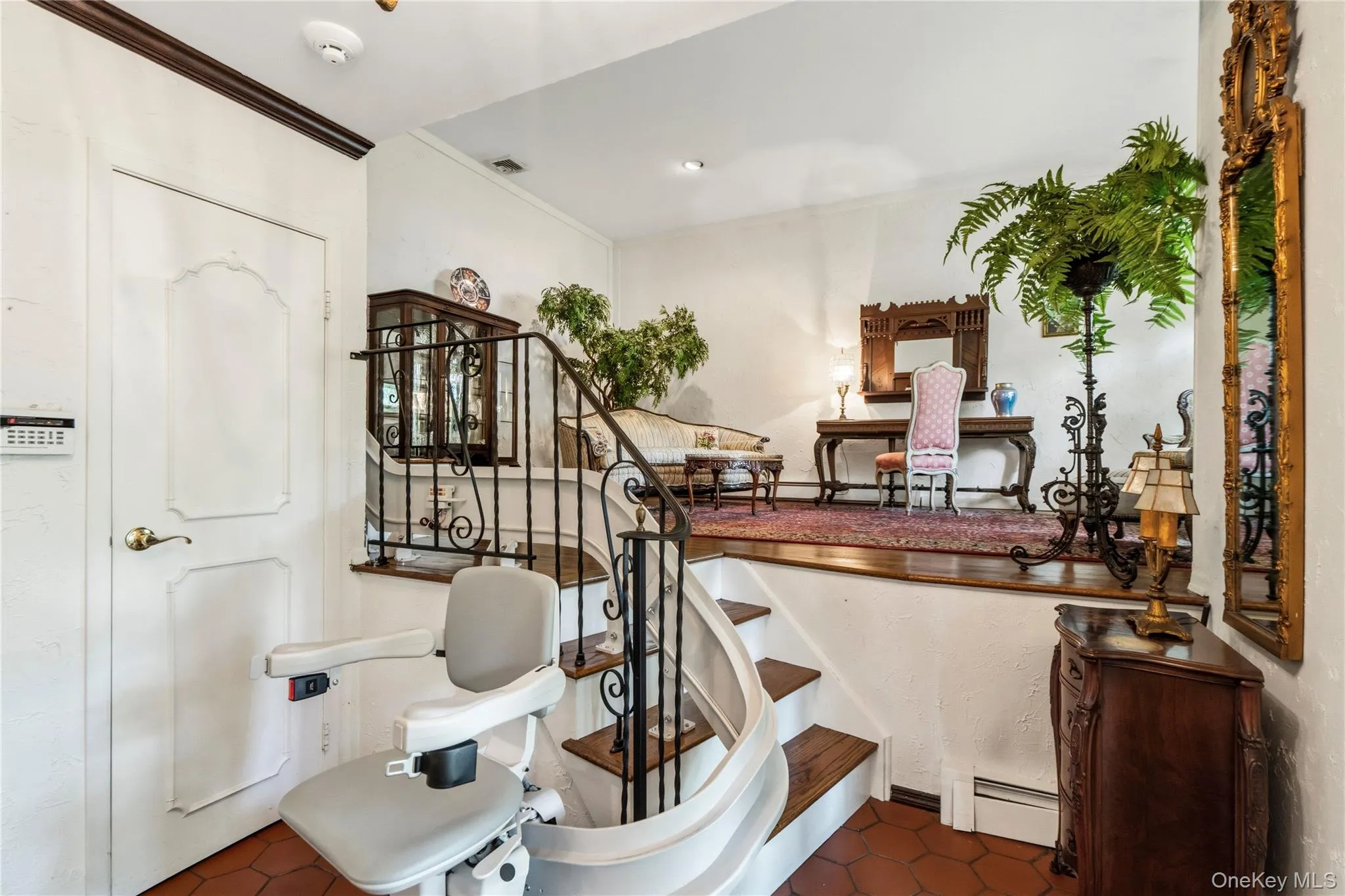 Dramatic living room off of entry way with curved staircase leading to four bedrooms Dramatic living room off of entry way with curved staircase leading to four bedrooms