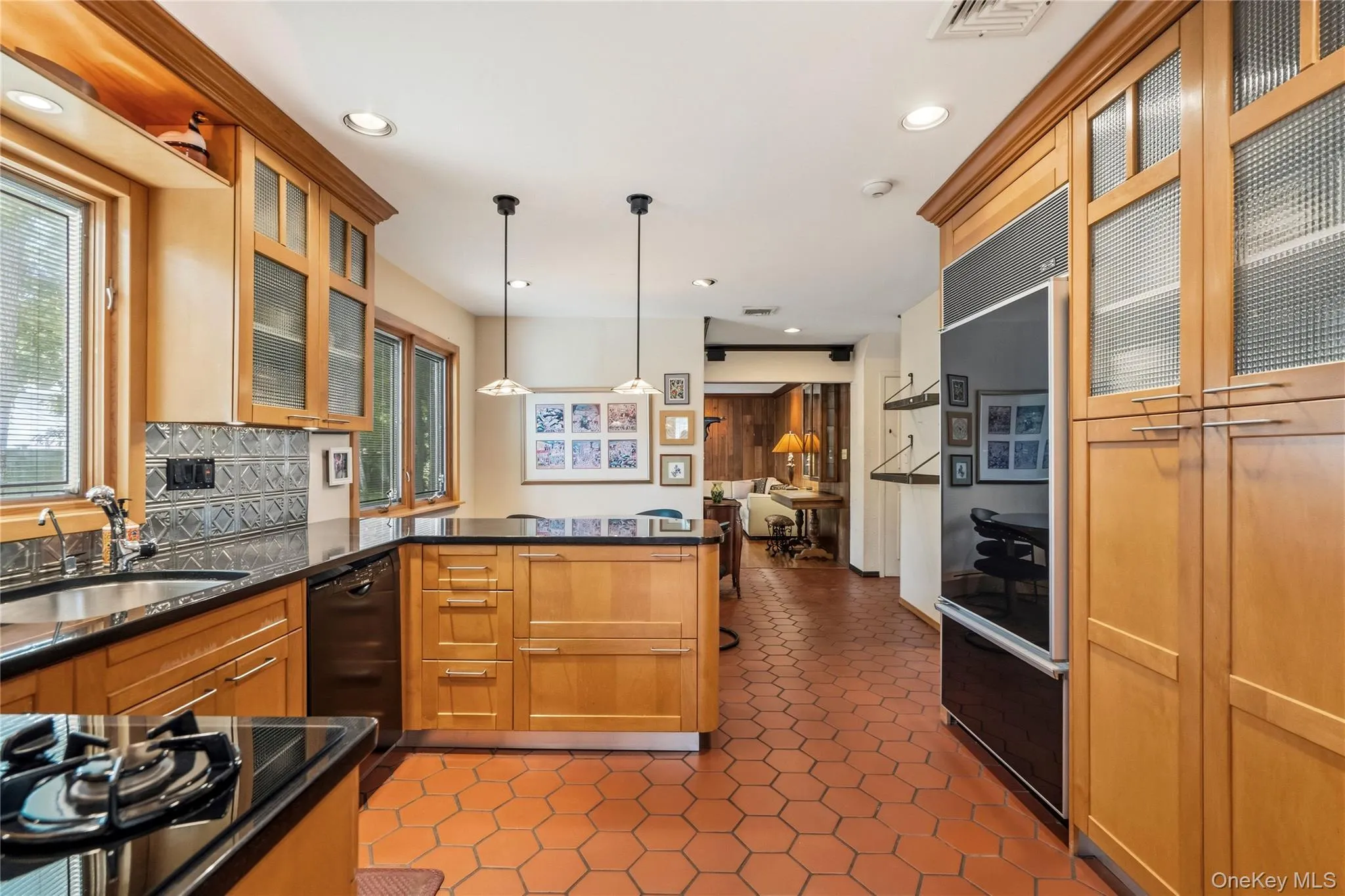 Cabinetry with frosted glass inserts, a built-in double oven, and a built-in refrigerator Cabinetry with frosted glass inserts, a built-in double oven, and a built-in refrigerator