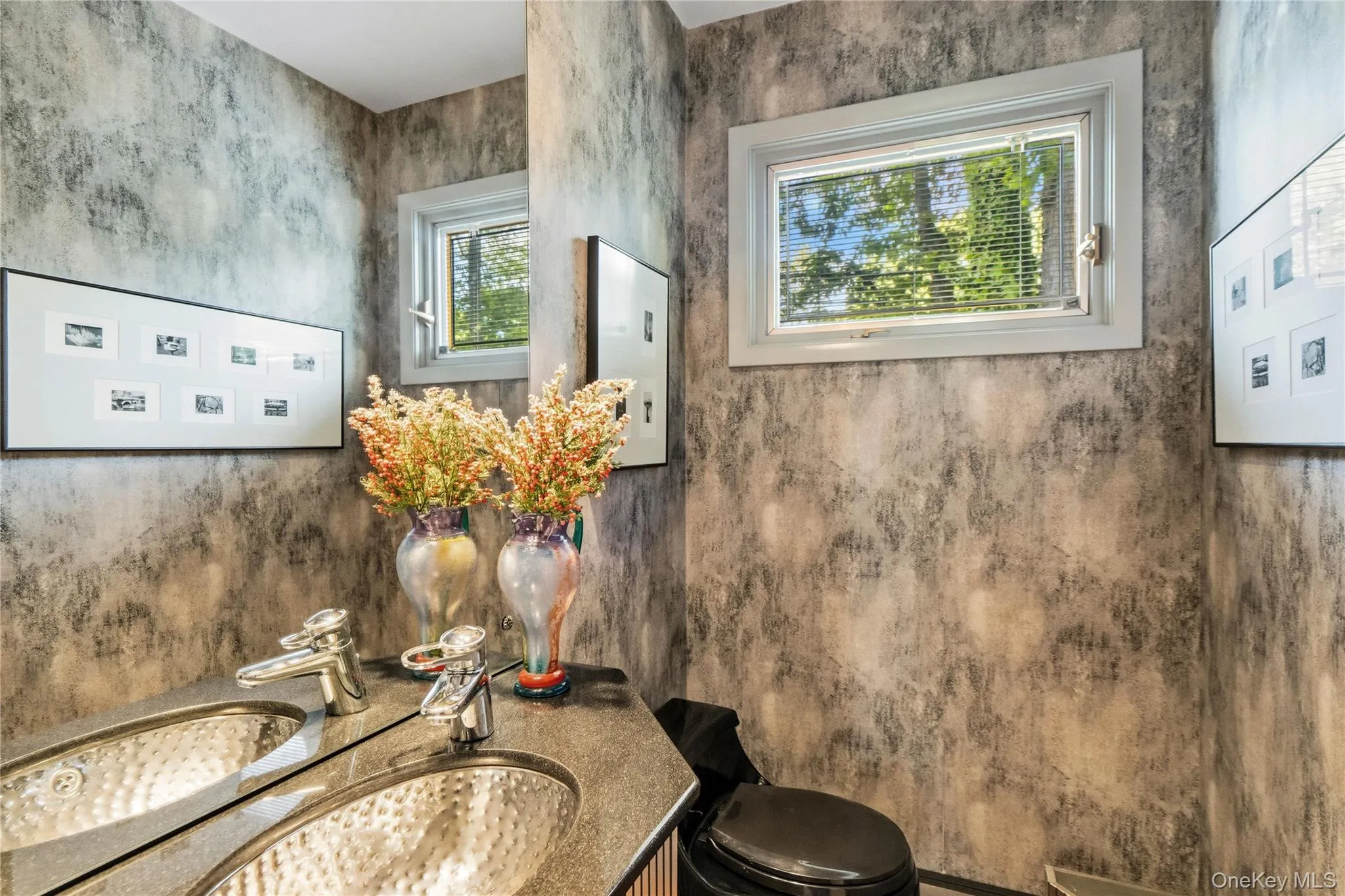 Bathroom featuring a custom vanity with hammered vessel sink, and an updated window Bathroom featuring a custom vanity with hammered vessel sink, and an updated window