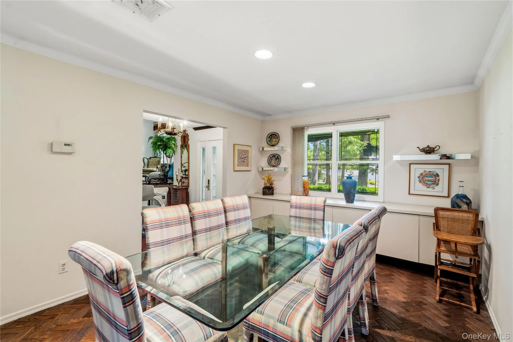 Dining area featuring wood flooring, recessed lighting, and a built-in credenza with floating shelves Dining area featuring wood flooring, recessed lighting, and a built-in credenza with floating shelves