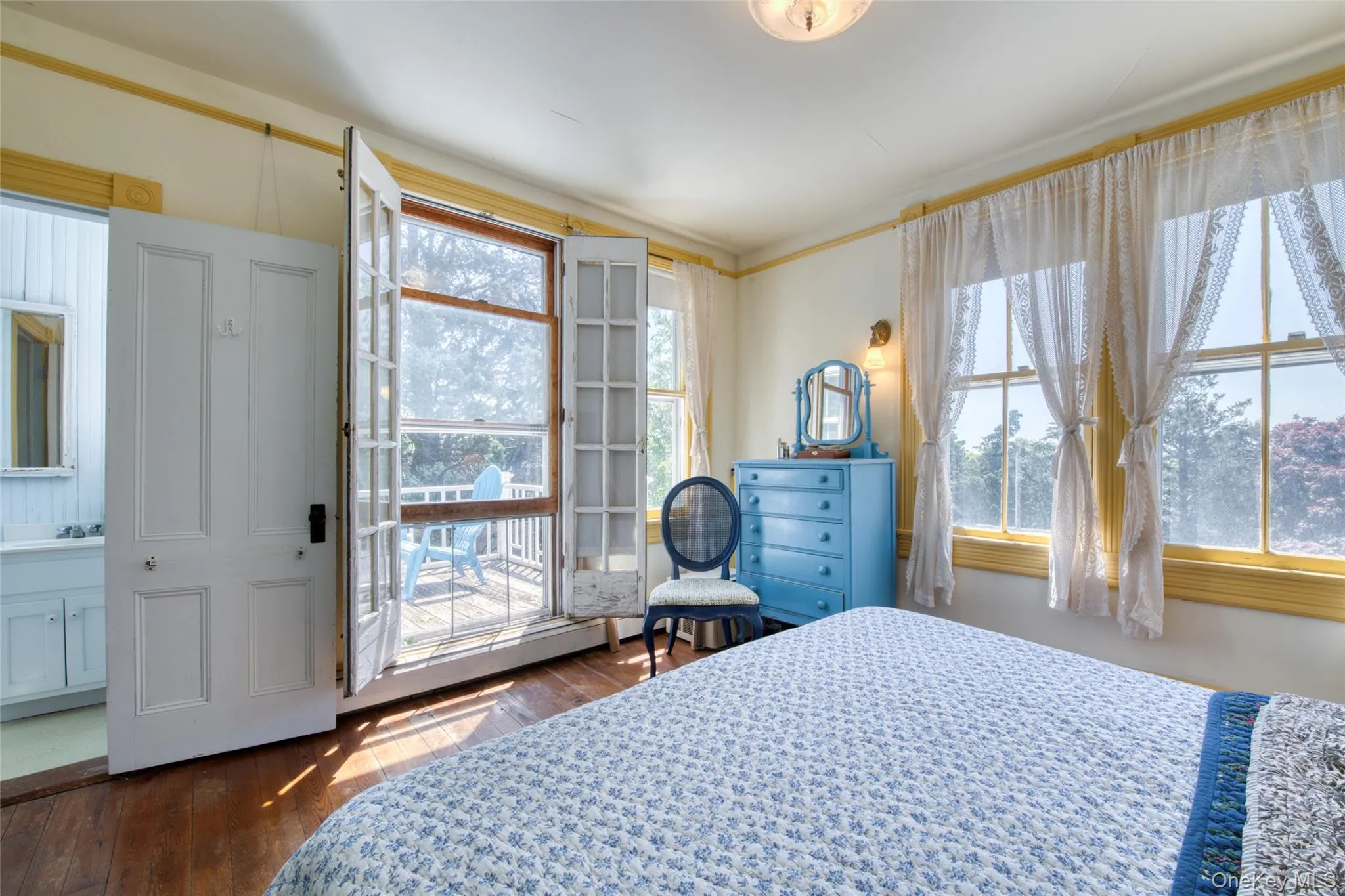 primary bedroom with half bath & private balcony primary bedroom with half bath & private balcony