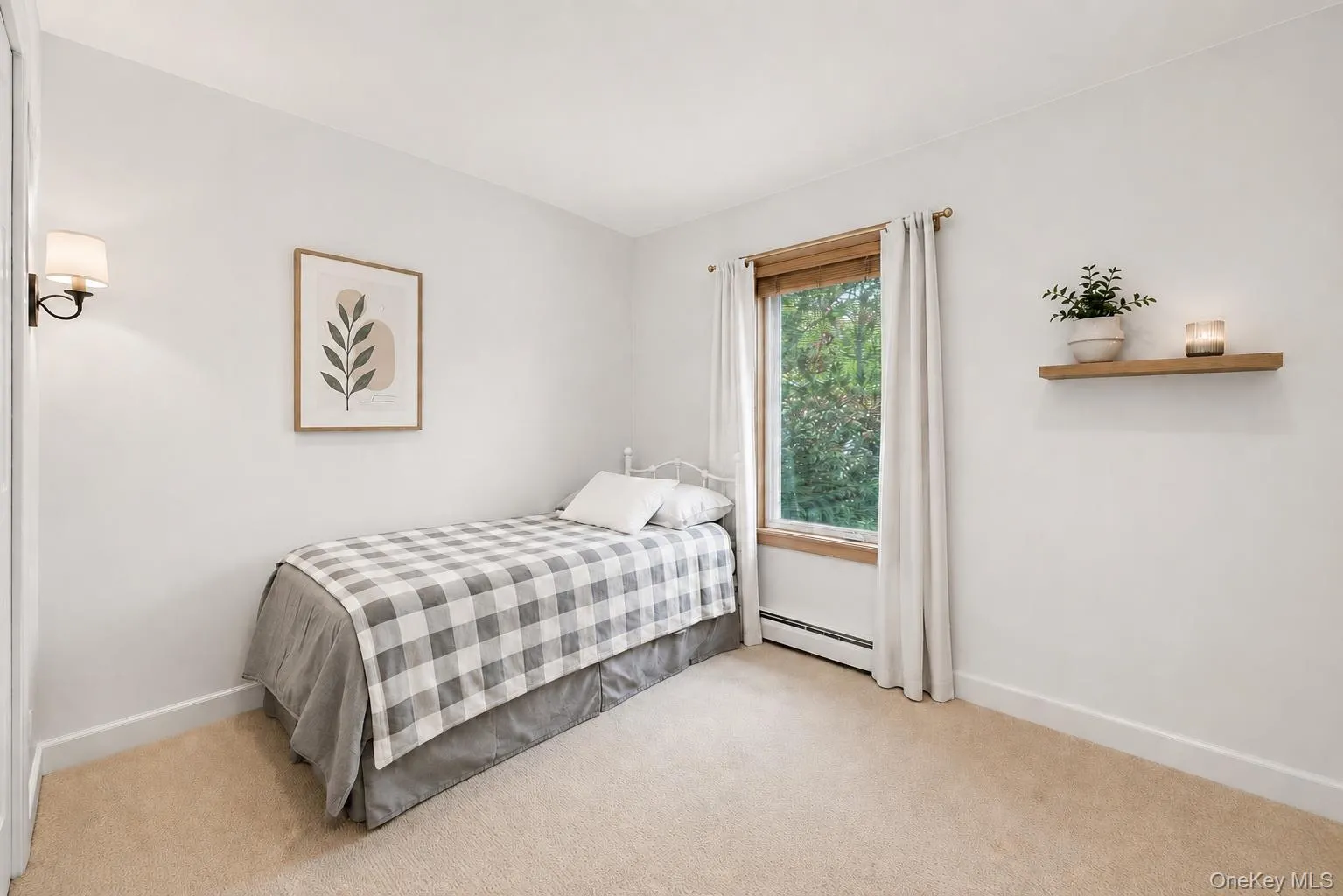 Carpeted room with a single window featuring wood trim Carpeted room with a single window featuring wood trim