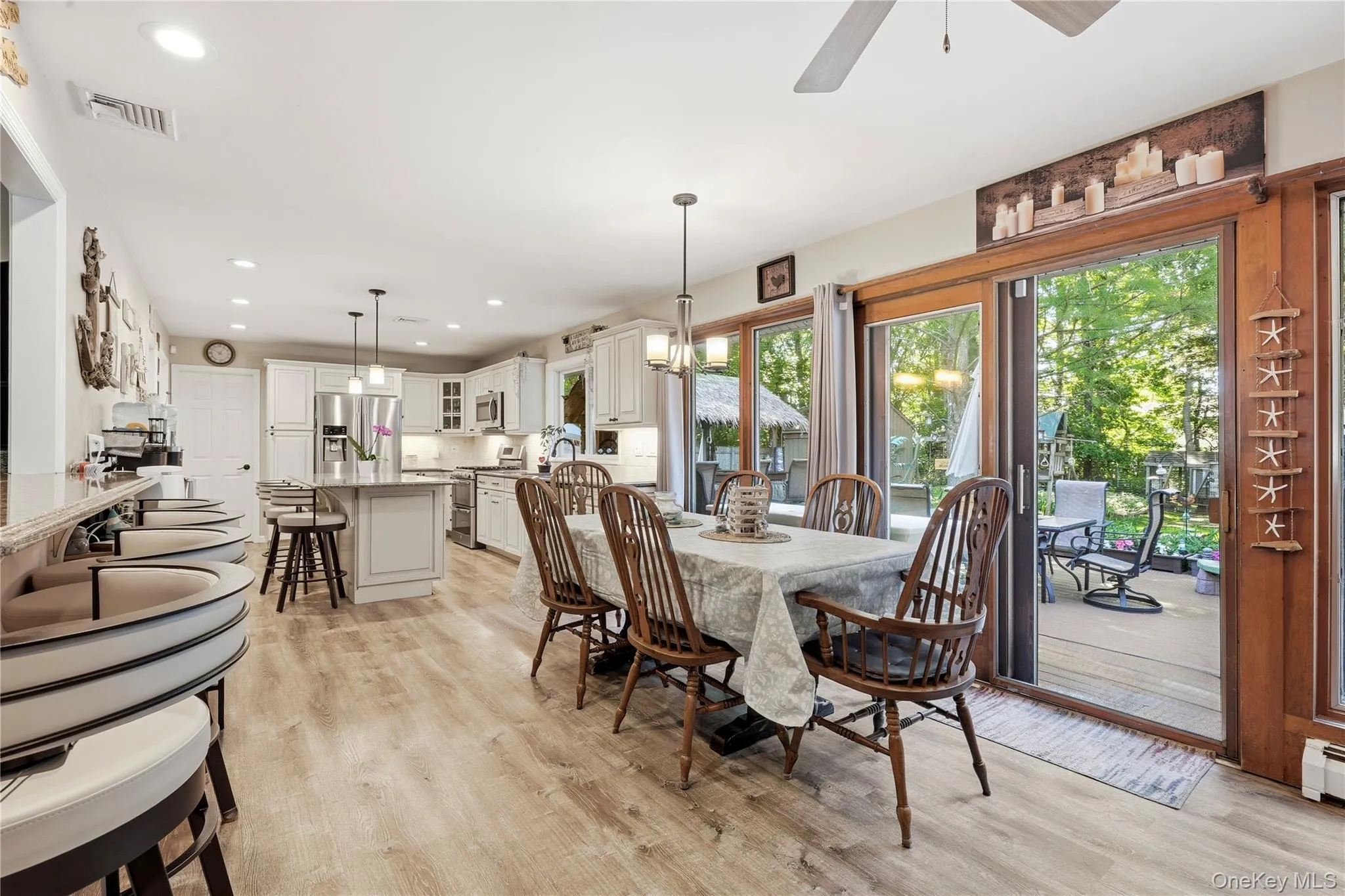 Open-concept kitchen and dining area featuring light wood-finish flooring Open-concept kitchen and dining area featuring light wood-finish flooring