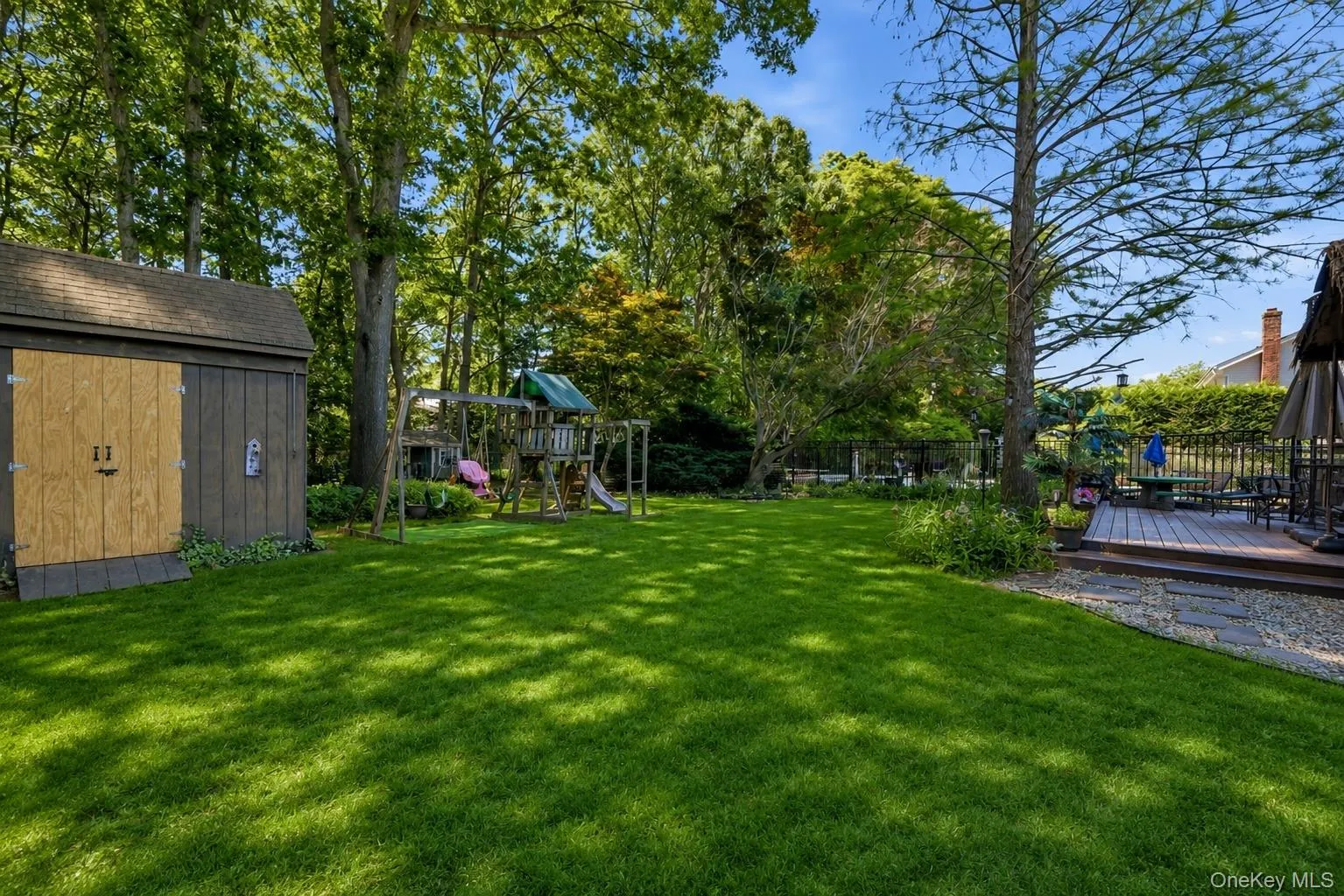 Expansive green lawn providing ample outdoor space Expansive green lawn providing ample outdoor space