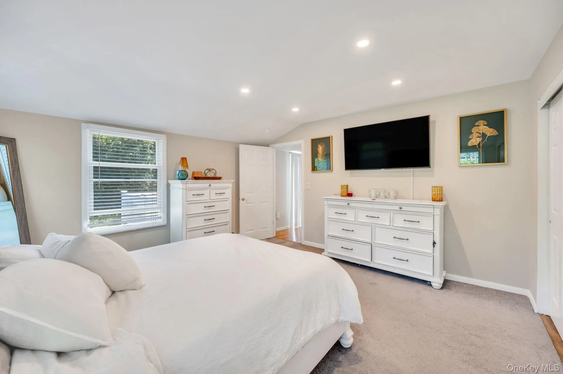 Carpeted bedroom with recessed lighting and a window featuring horizontal blinds Carpeted bedroom with recessed lighting and a window featuring horizontal blinds