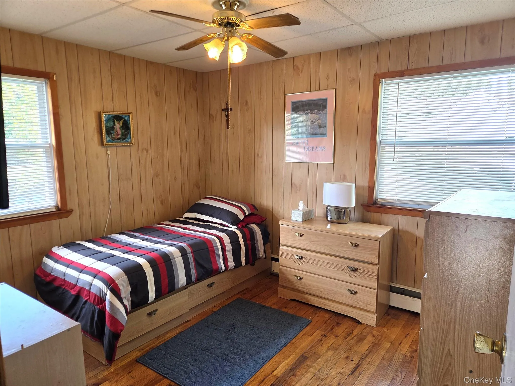 The Well Sized Second Bedroom Offers Beautiful Hardwood Floors, Two Large Windows For Natural Light, Ceiling Fan, Good Sized Closet & Ample Room For Furniture. The Well Sized Second Bedroom Offers Beautiful Hardwood Floors, Two Large Windows For Natural Light, Ceiling Fan, Good Sized Closet & Ample Room For Furniture.
