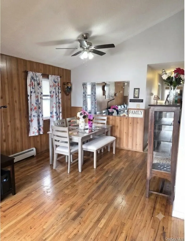 Another View Of The Comfortable Dining Room Offering Vaulted Ceilings, Ceiling Fan, Beautiful Hardwood Floors, Double Window For Natural Light, Room For A Good Sized Table & Chairs, And Opens Into The Kitchen. Another View Of The Comfortable Dining Room Offering Vaulted Ceilings, Ceiling Fan, Beautiful Hardwood Floors, Double Window For Natural Light, Room For A Good Sized Table & Chairs, And Opens Into The Kitchen.