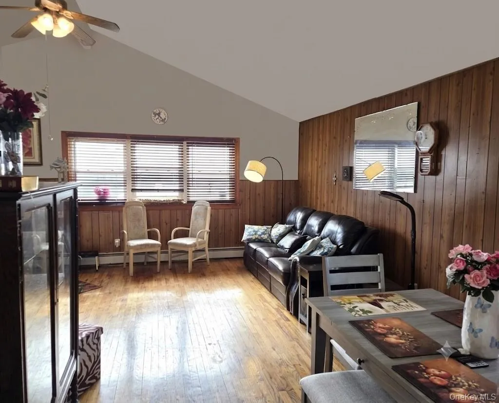 The Open Living Room & Dining Room Offers A Large Open Space - Perfect For Entertaining Family & Friends, And Holiday Get Togethers...It Has Beautiful Hardwood Floors, Vaulted Ceilings, A Triple Window For Natural Light & Ample Room For Furniture. The Open Living Room & Dining Room Offers A Large Open Space - Perfect For Entertaining Family & Friends, And Holiday Get Togethers...It Has Beautiful Hardwood Floors, Vaulted Ceilings, A Triple Window For Natural Light & Ample Room For Furniture.