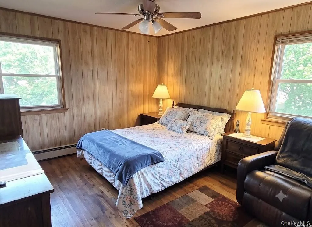 The Well Sized, Inviting Primary Bedroom Offers Two Large Windows For Natural Light, Beautiful Hardwood Floors, Ceiling Fan, Large Full Wall Closet & Ample Room For A Good Sized Bedroom Set/Furniture. The Well Sized, Inviting Primary Bedroom Offers Two Large Windows For Natural Light, Beautiful Hardwood Floors, Ceiling Fan, Large Full Wall Closet & Ample Room For A Good Sized Bedroom Set/Furniture.