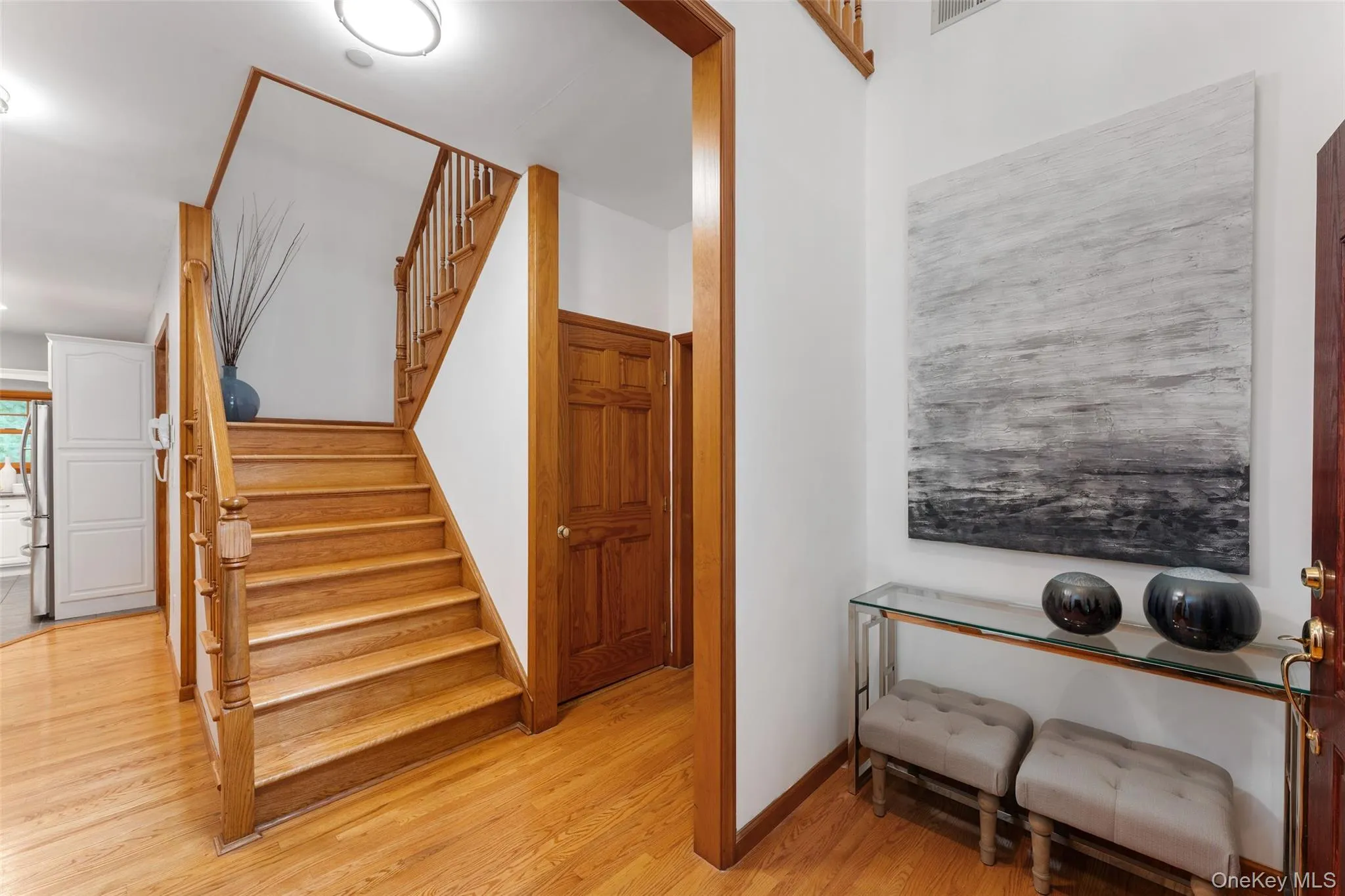 Hardwood staircase with matching banister and wood-finish flooring Hardwood staircase with matching banister and wood-finish flooring