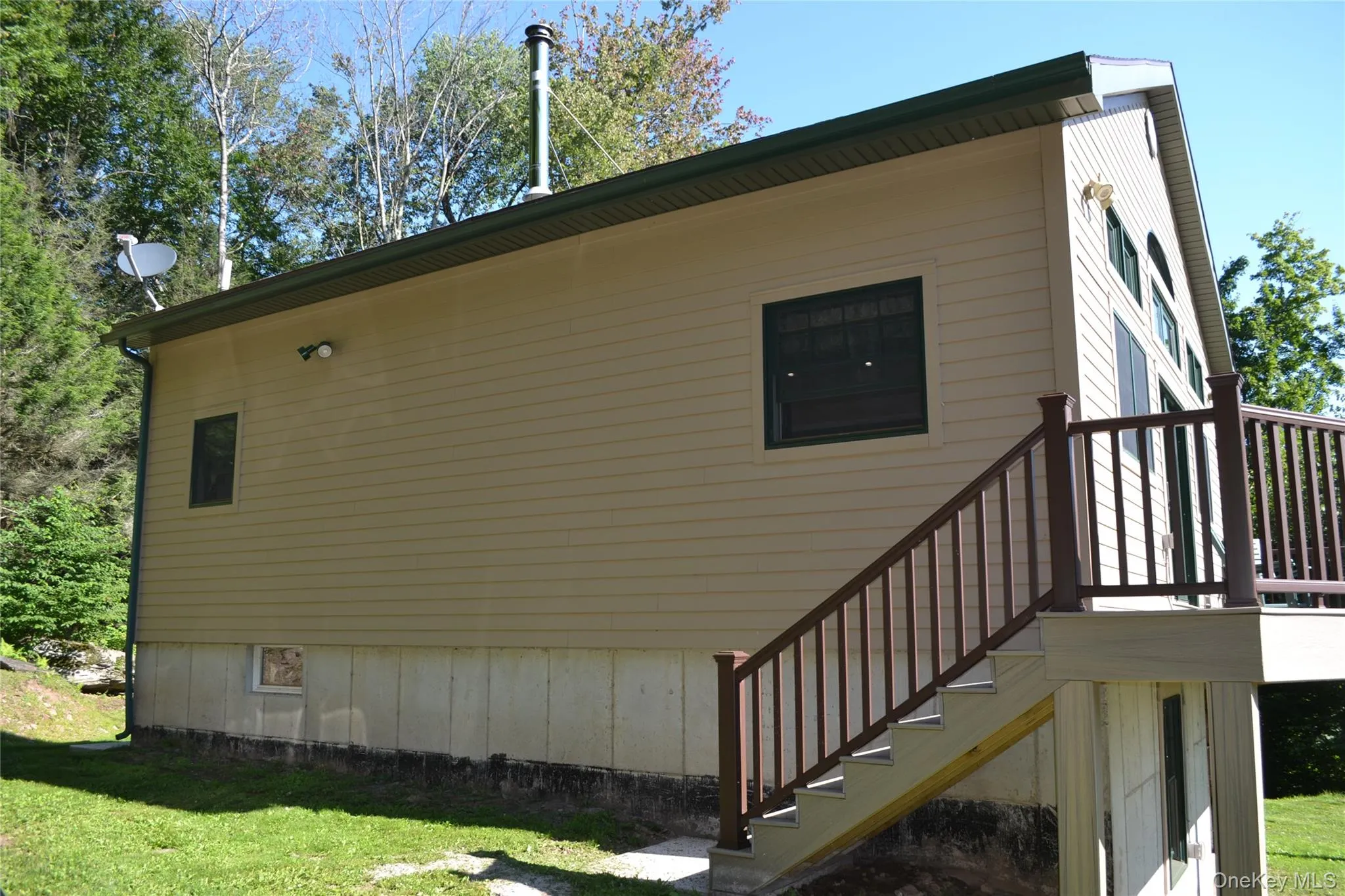 Side of home with stairs to front and back decks Side of home with stairs to front and back decks