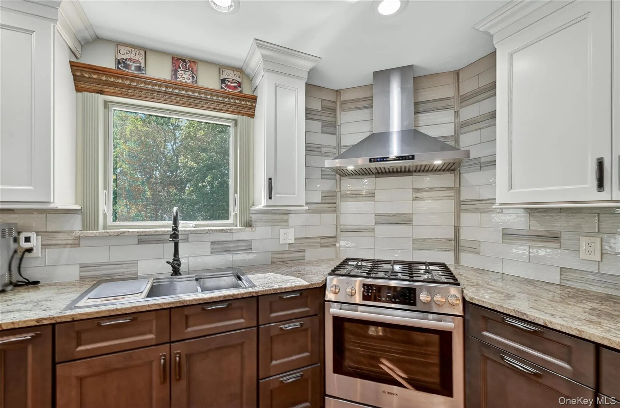 The double sink, stainless steel hood and five burner range help make everyone a gourmet chef. The double sink, stainless steel hood and five burner range help make everyone a gourmet chef.