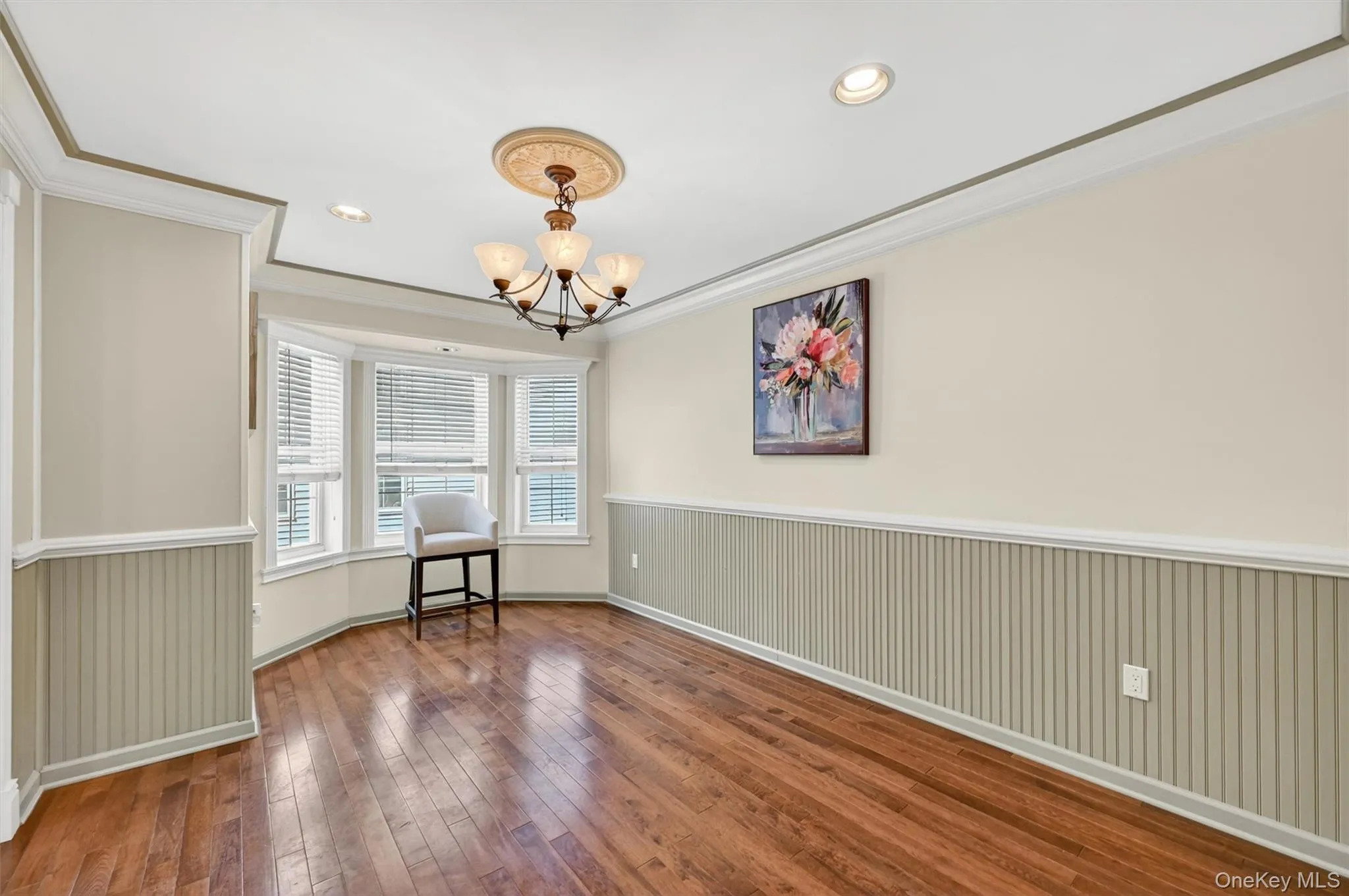 The formal dining room as an arched windowed wall, chair molding and recessed lights. The formal dining room as an arched windowed wall, chair molding and recessed lights.