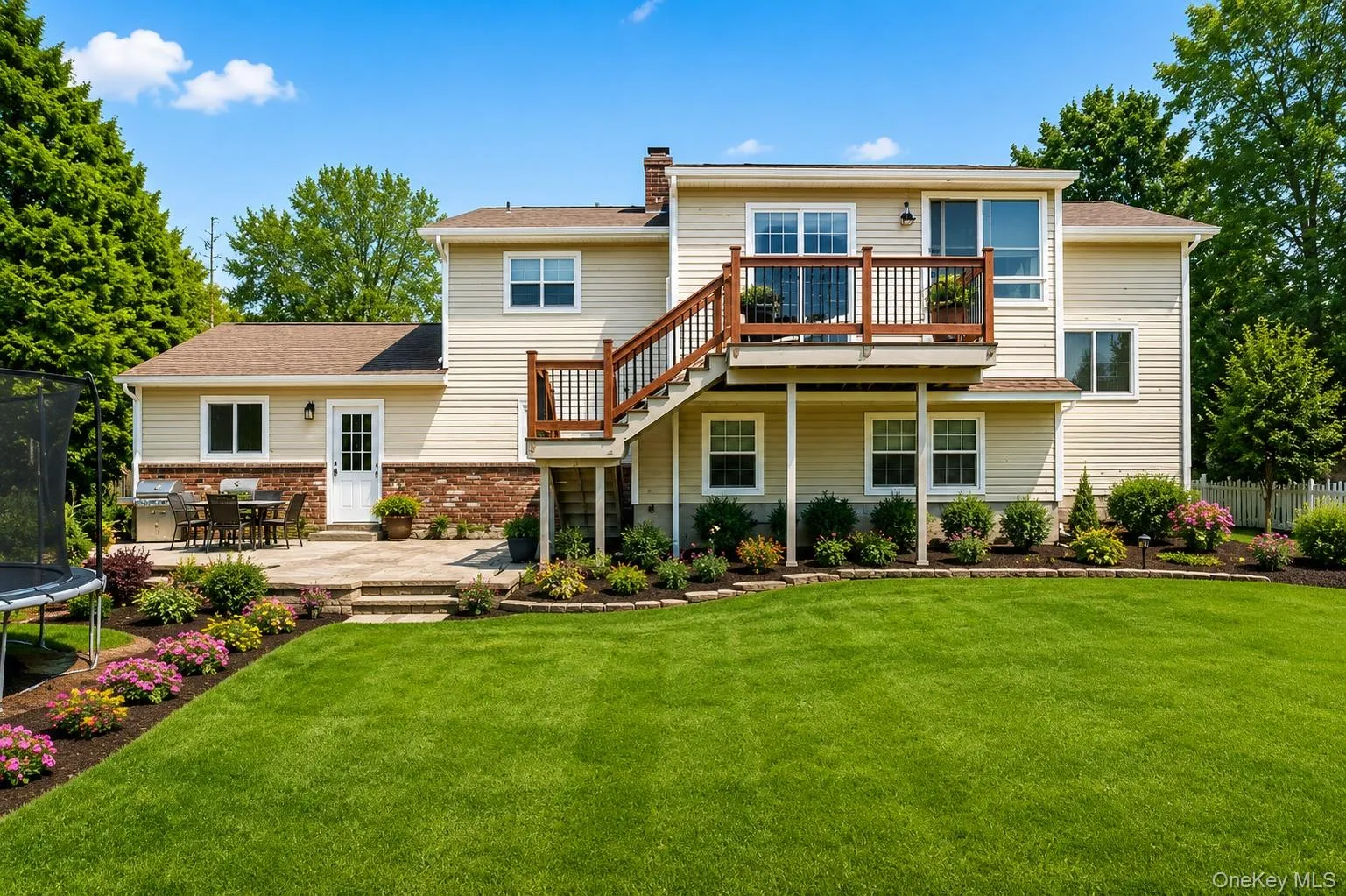 Two-story residence with a multi-level deck and stone patio Two-story residence with a multi-level deck and stone patio