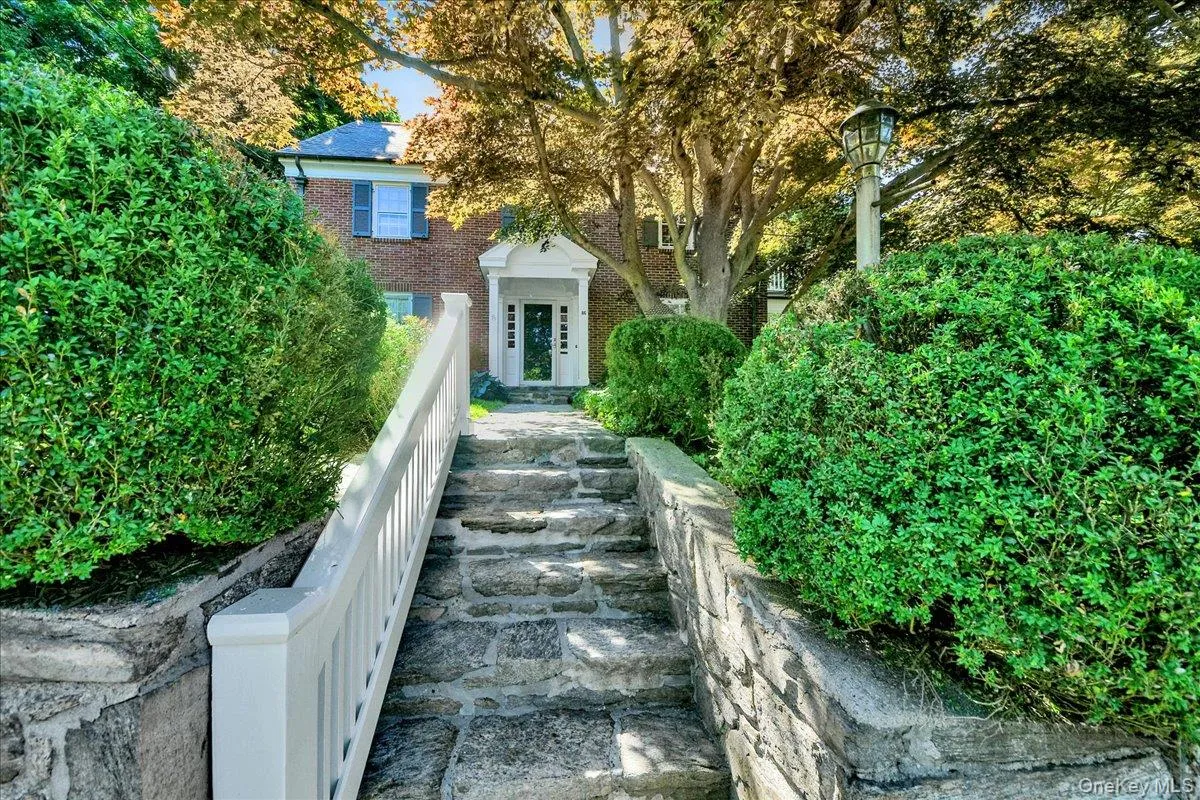 Brick exterior with white columned portico entry Brick exterior with white columned portico entry