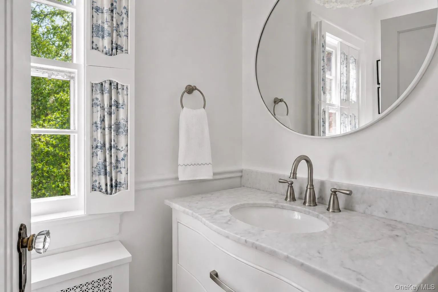 Main Floor Half Bathroom featuring a white vanity with an undermount sink and a stone countertop Main Floor Half Bathroom featuring a white vanity with an undermount sink and a stone countertop