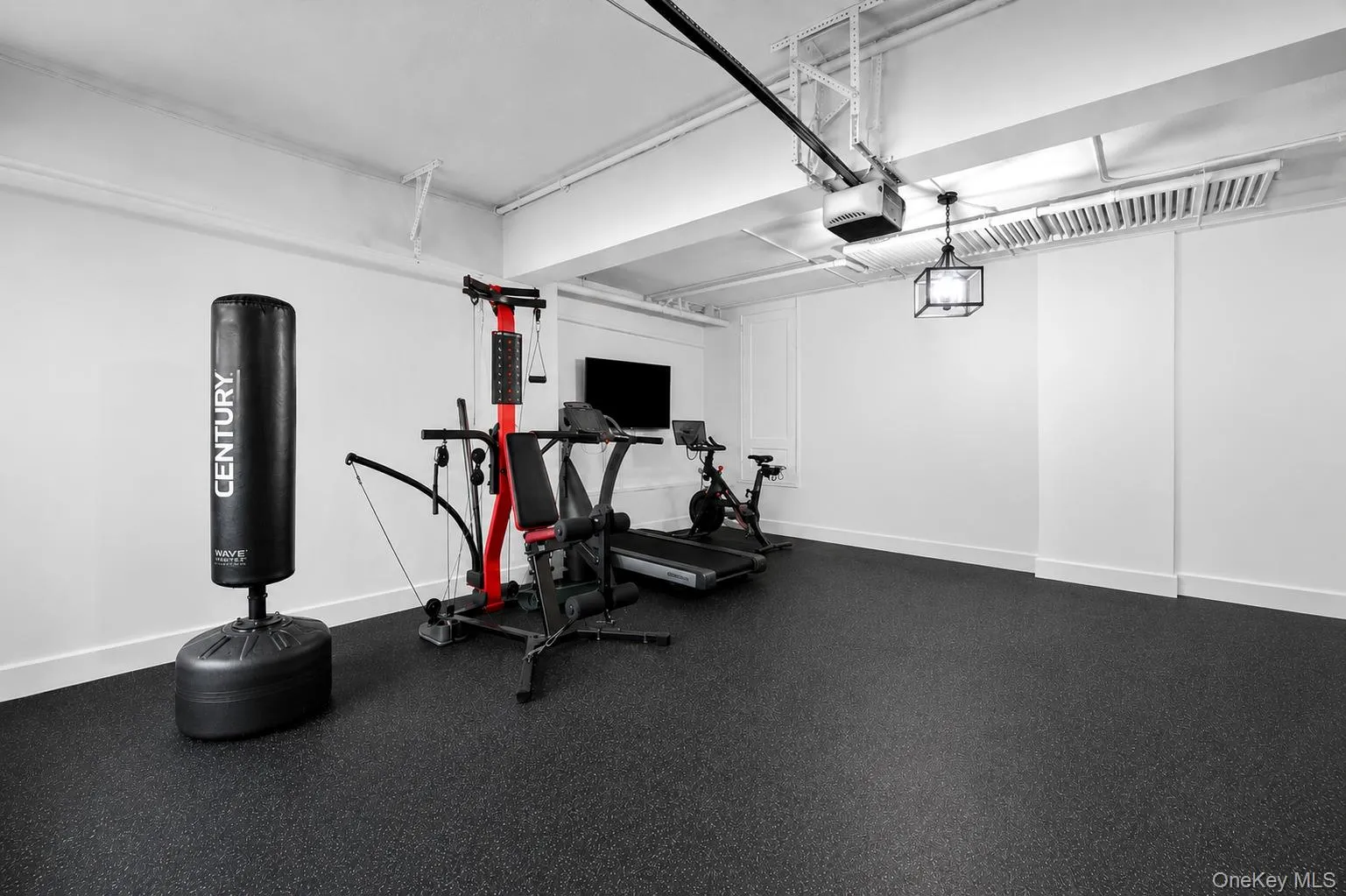 Spacious interior room with dark, textured flooring accessed through the basement. Spacious interior room with dark, textured flooring accessed through the basement.