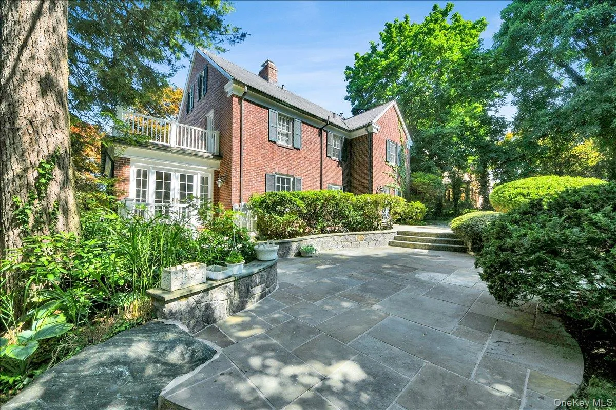 Expansive stone Backyard patio featuring a multi-tiered design with integrated stone retaining walls Expansive stone Backyard patio featuring a multi-tiered design with integrated stone retaining walls
