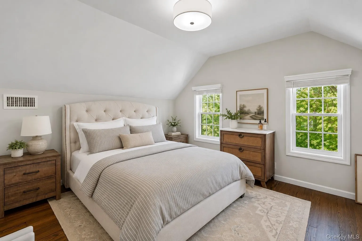Top floor/attic bedroom featuring vaulted ceilings and dark wood-finish flooring Top floor/attic bedroom featuring vaulted ceilings and dark wood-finish flooring