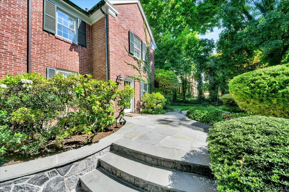 Expansive stone Backyard patio featuring a multi-tiered design with integrated stone retaining walls Expansive stone Backyard patio featuring a multi-tiered design with integrated stone retaining walls