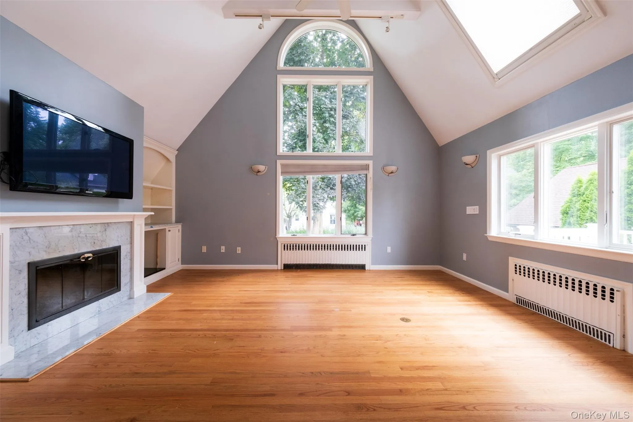 Great room with vaulted ceilings and wood burning fireplace Great room with vaulted ceilings and wood burning fireplace