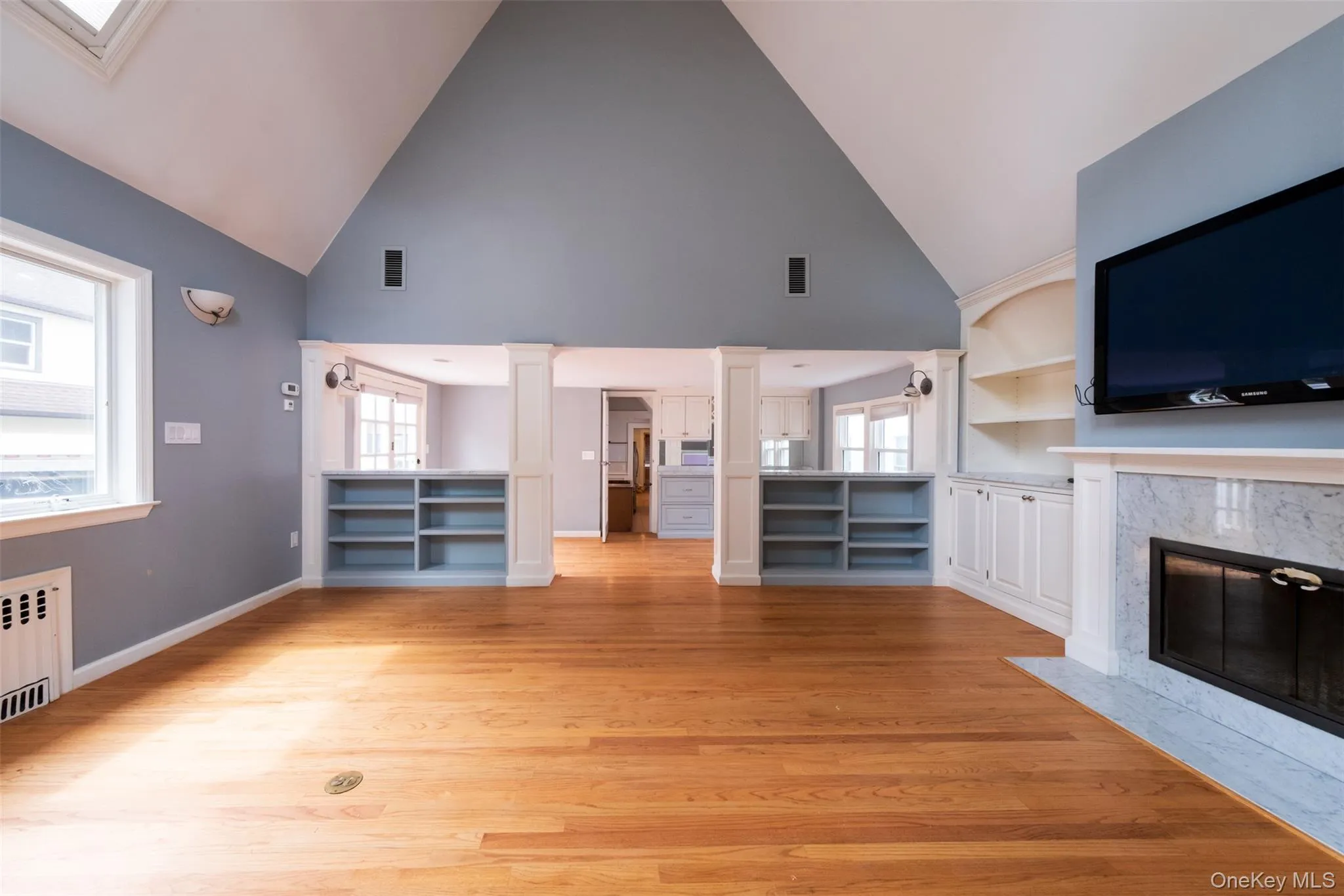 Great room with vaulted ceilings and wood burning fireplace Great room with vaulted ceilings and wood burning fireplace