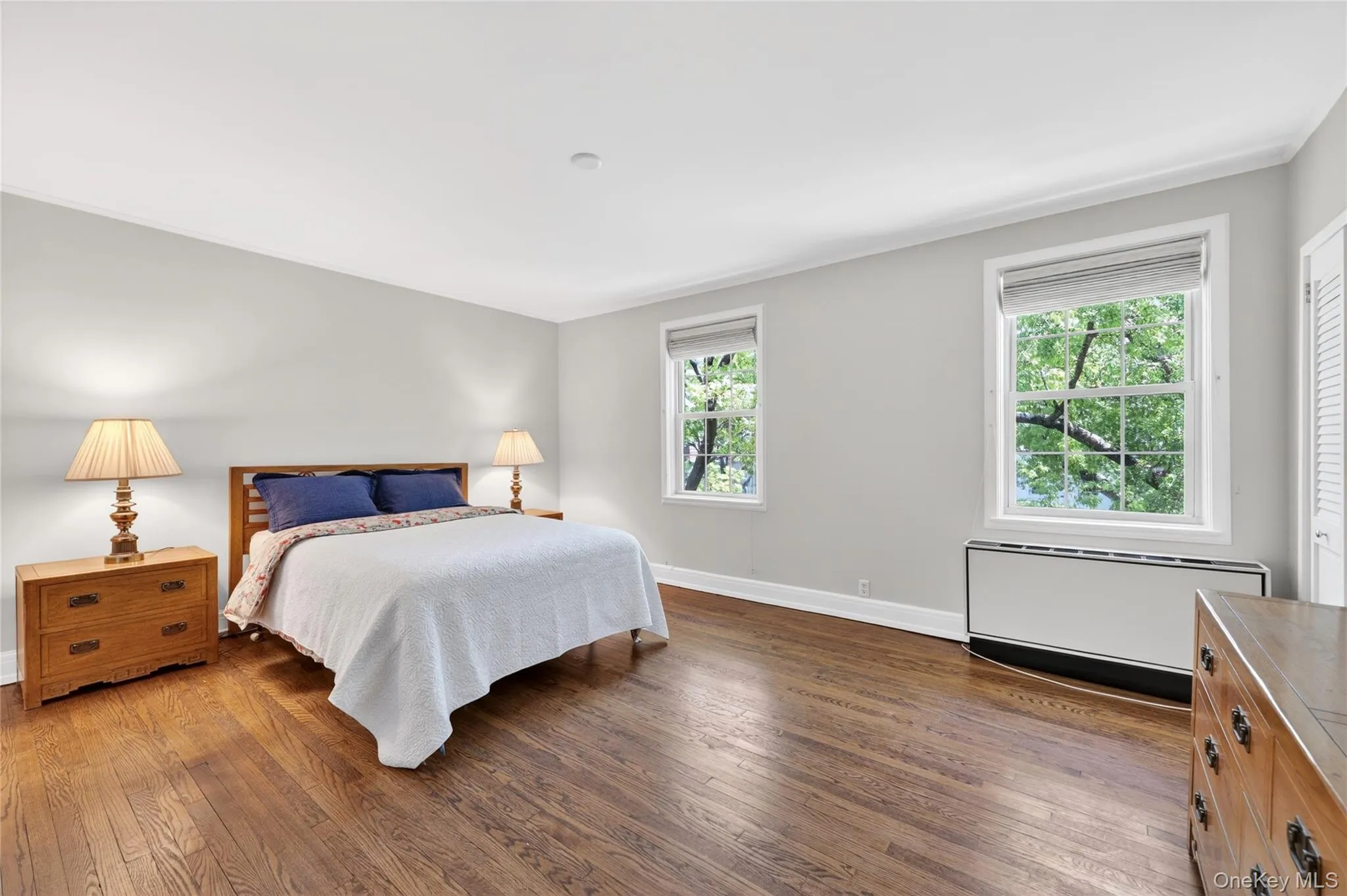 Spacious Primary Bedroom facing East with Beautiful Hardwood Floors, and Full bathroom Spacious Primary Bedroom facing East with Beautiful Hardwood Floors, and Full bathroom
